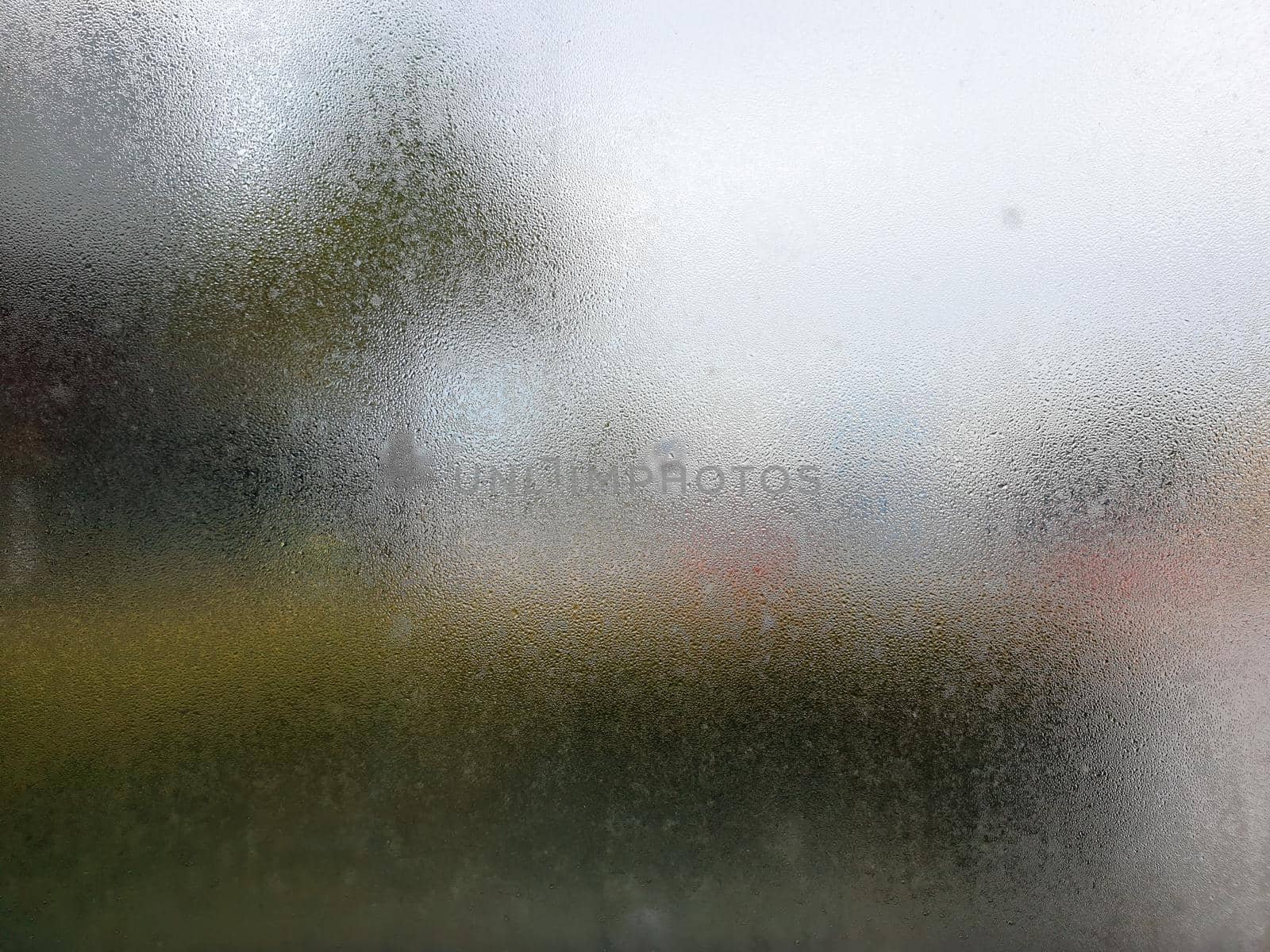 Water drops steam of rain on window glass after the rain