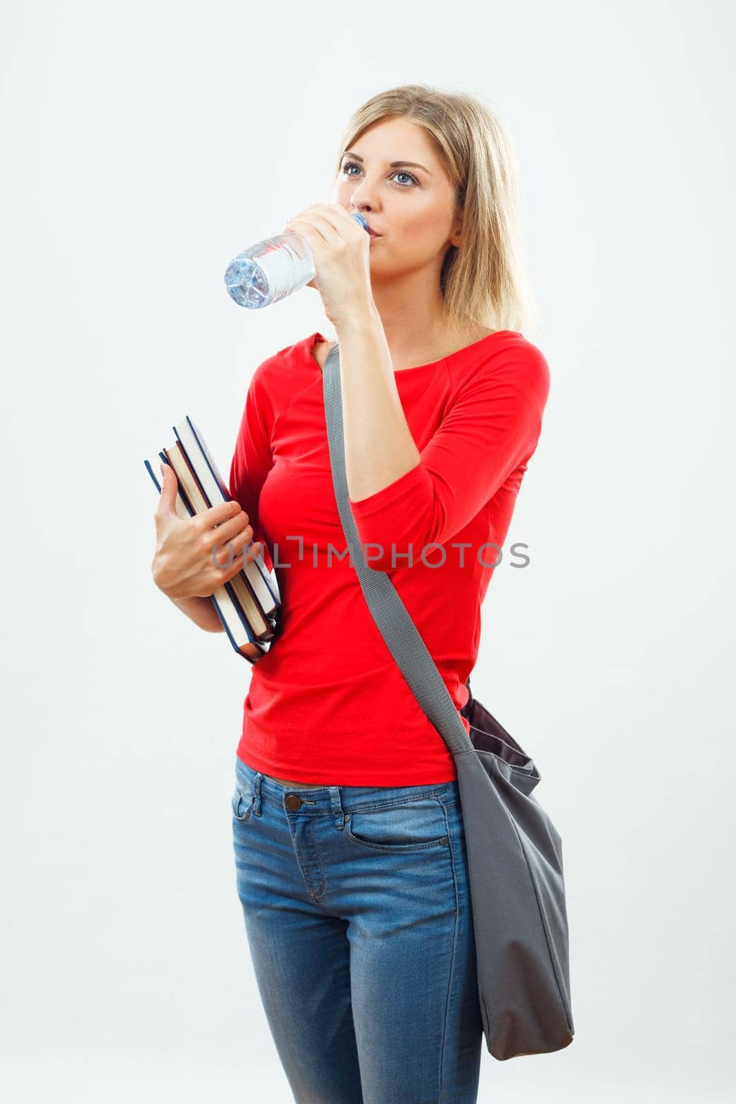 Female student drinking water.