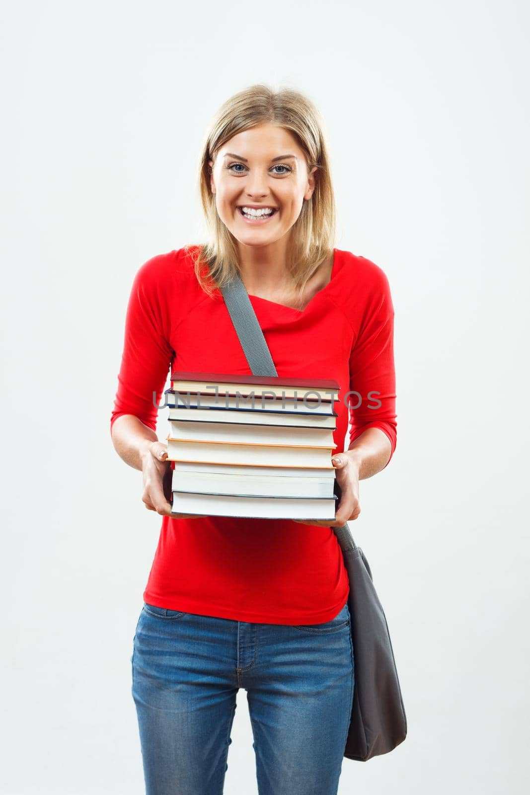 Portrait of happy female student holding books.