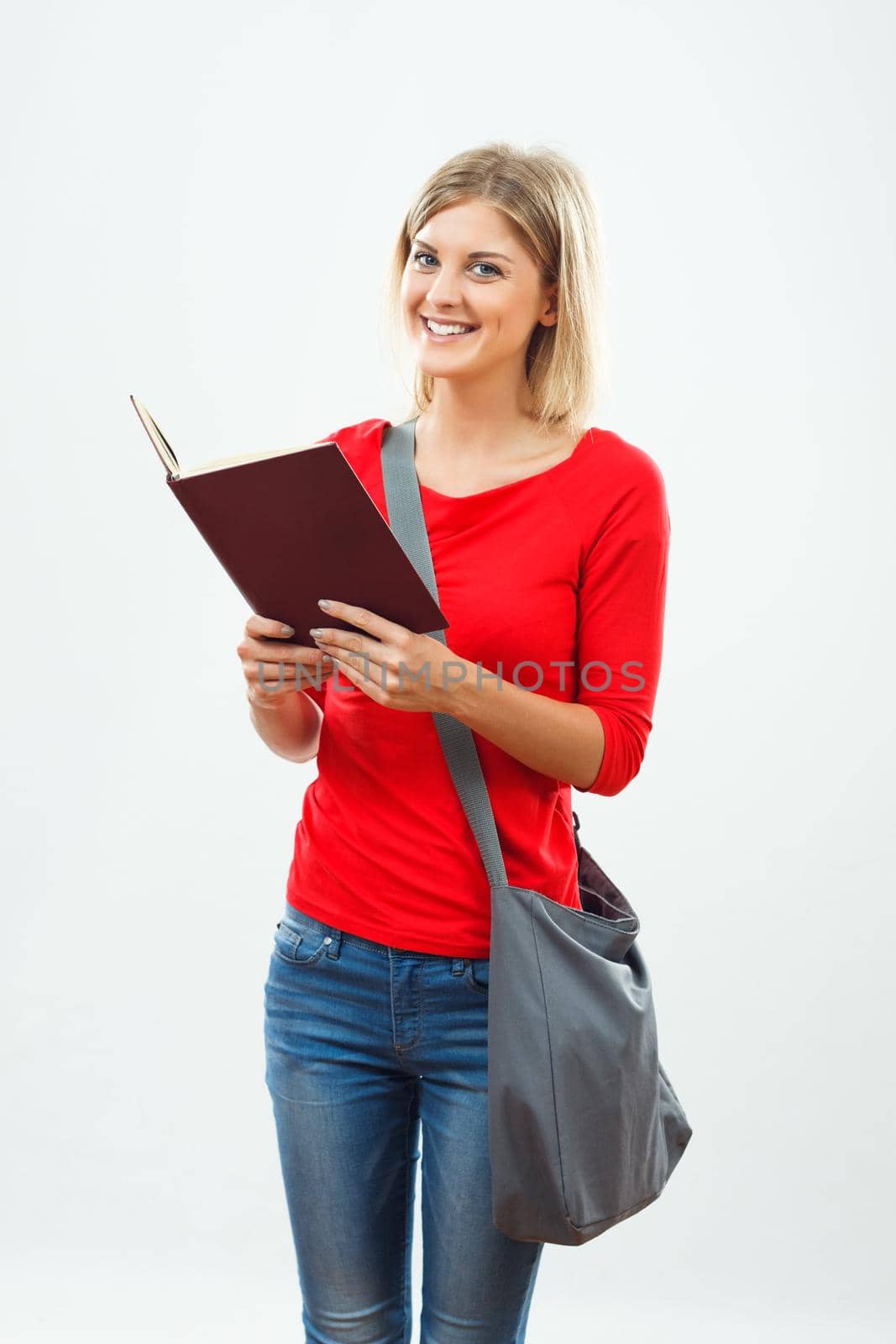 Portrait of female student reading a book.