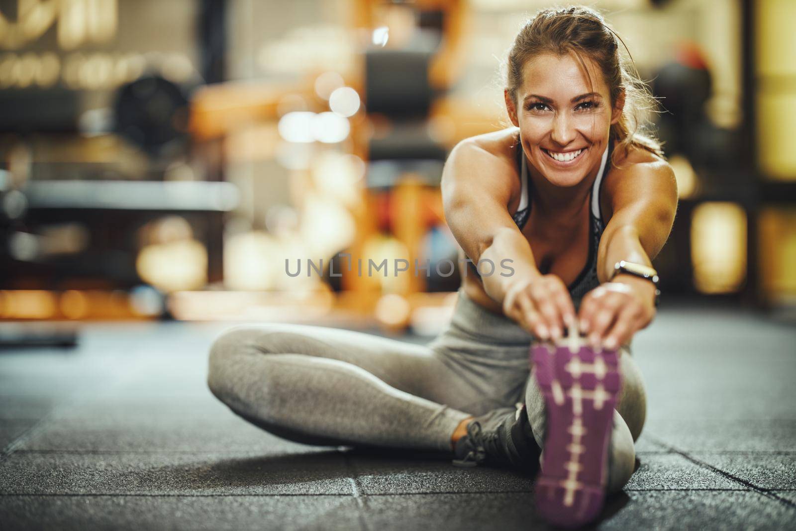 Shot of an attractive young woman doing stretching exercises at the gym.