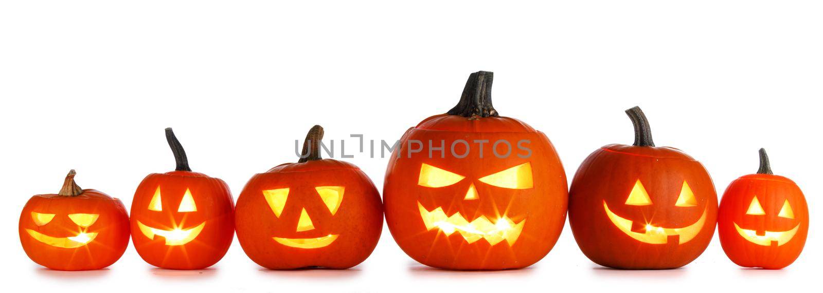 Six Halloween Pumpkins in a row isolated on white background