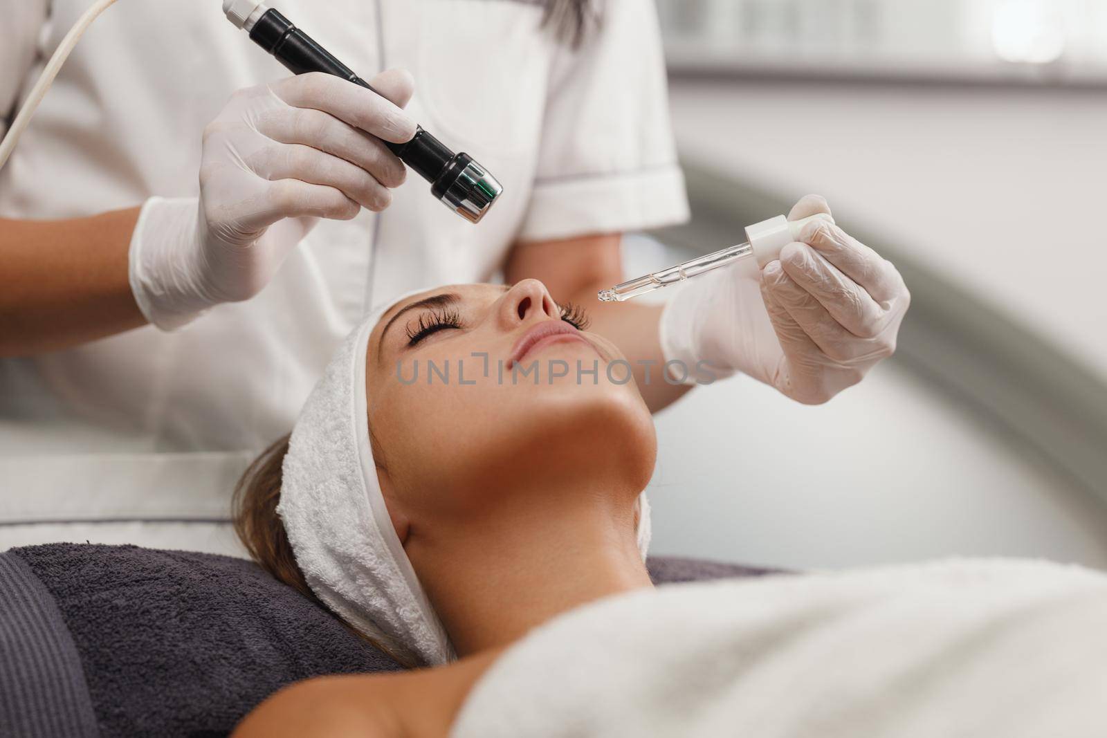 Shot of a beautiful young woman on a facial mesotherapy non needle treatment at the beauty salon.