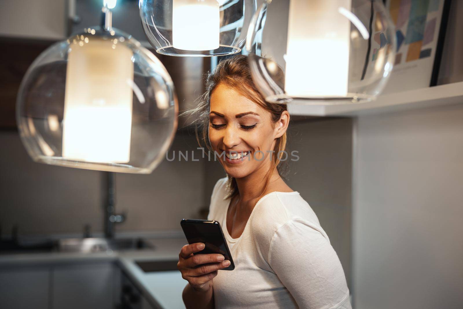 Attractive young woman using smartphone to surfing social media at home.