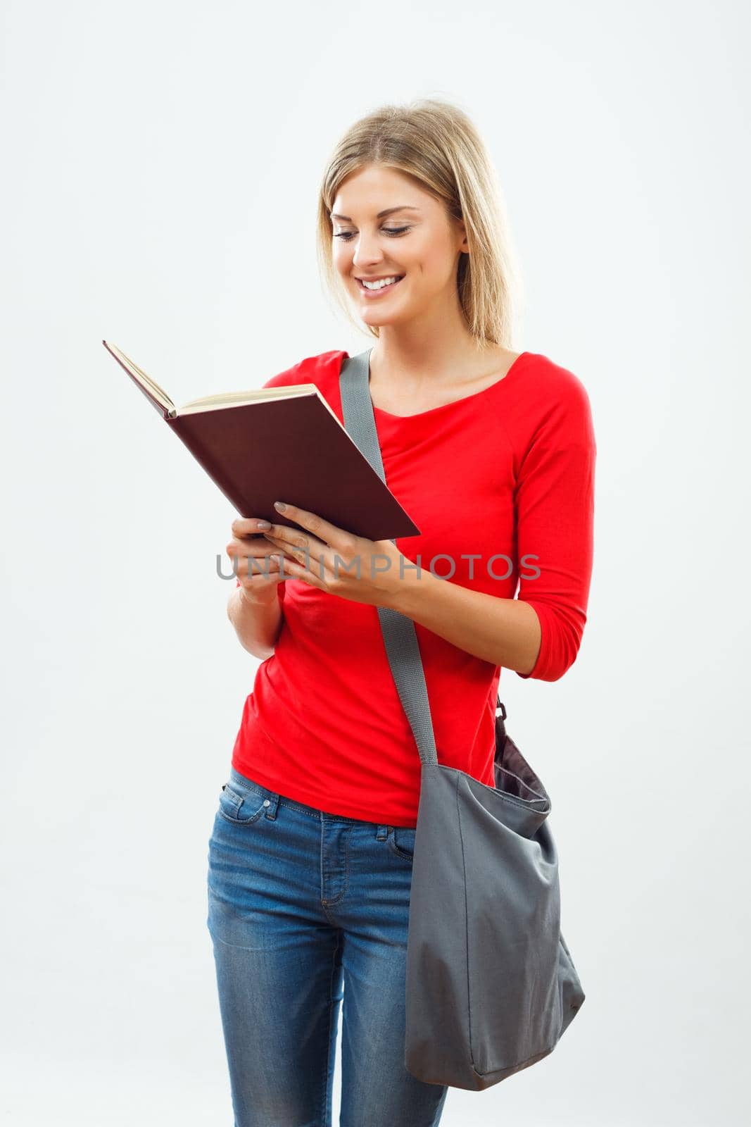 Image of female student reading a book.