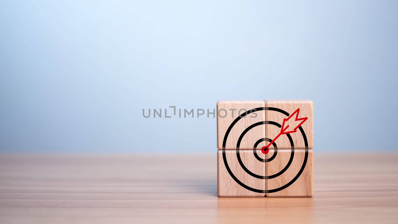 Wooden block and target icon placed on wooden background. Business concept. Management concept. Business planning concept. by Unimages2527