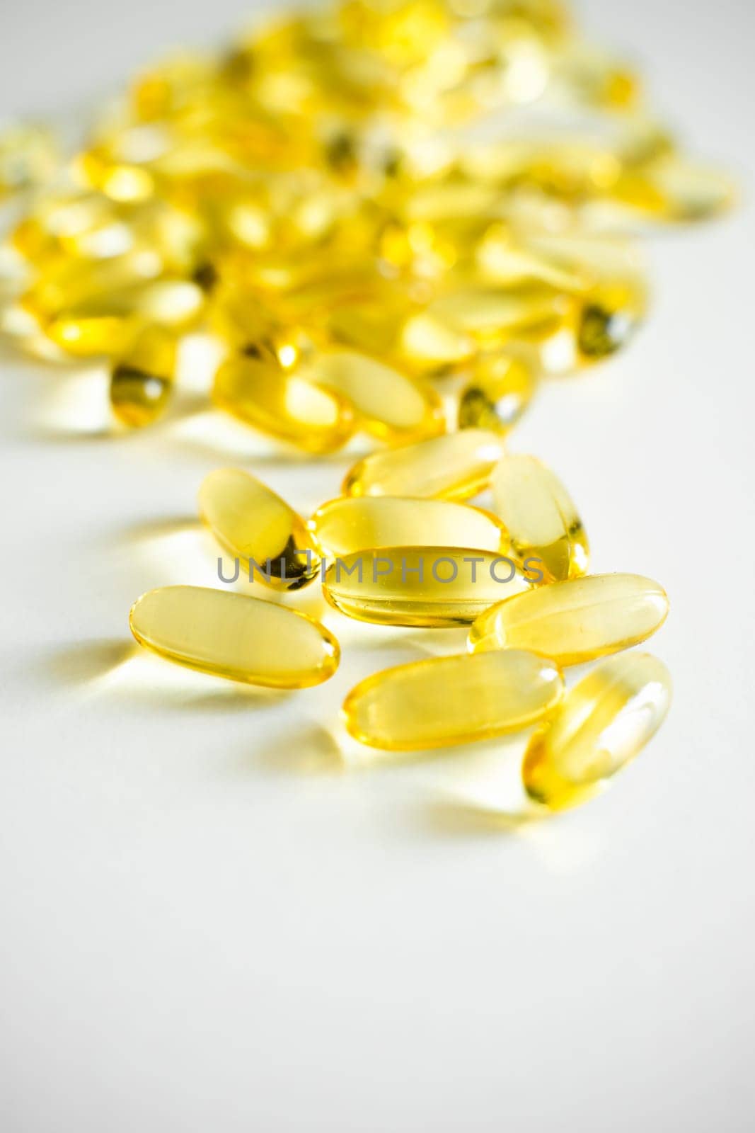 Fish oil supplement capsules on a white surface as a background. Oil filled capsules of food supplements. Fish oil, omega 3