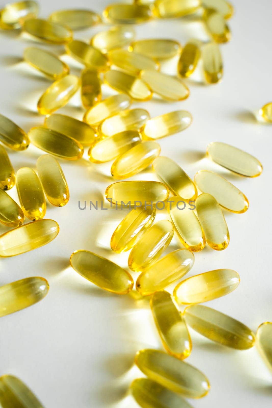 Gelatin capsules of omega 3, 6, 9 fish oil, vitamin isolated on a white surface as a background. by vovsht