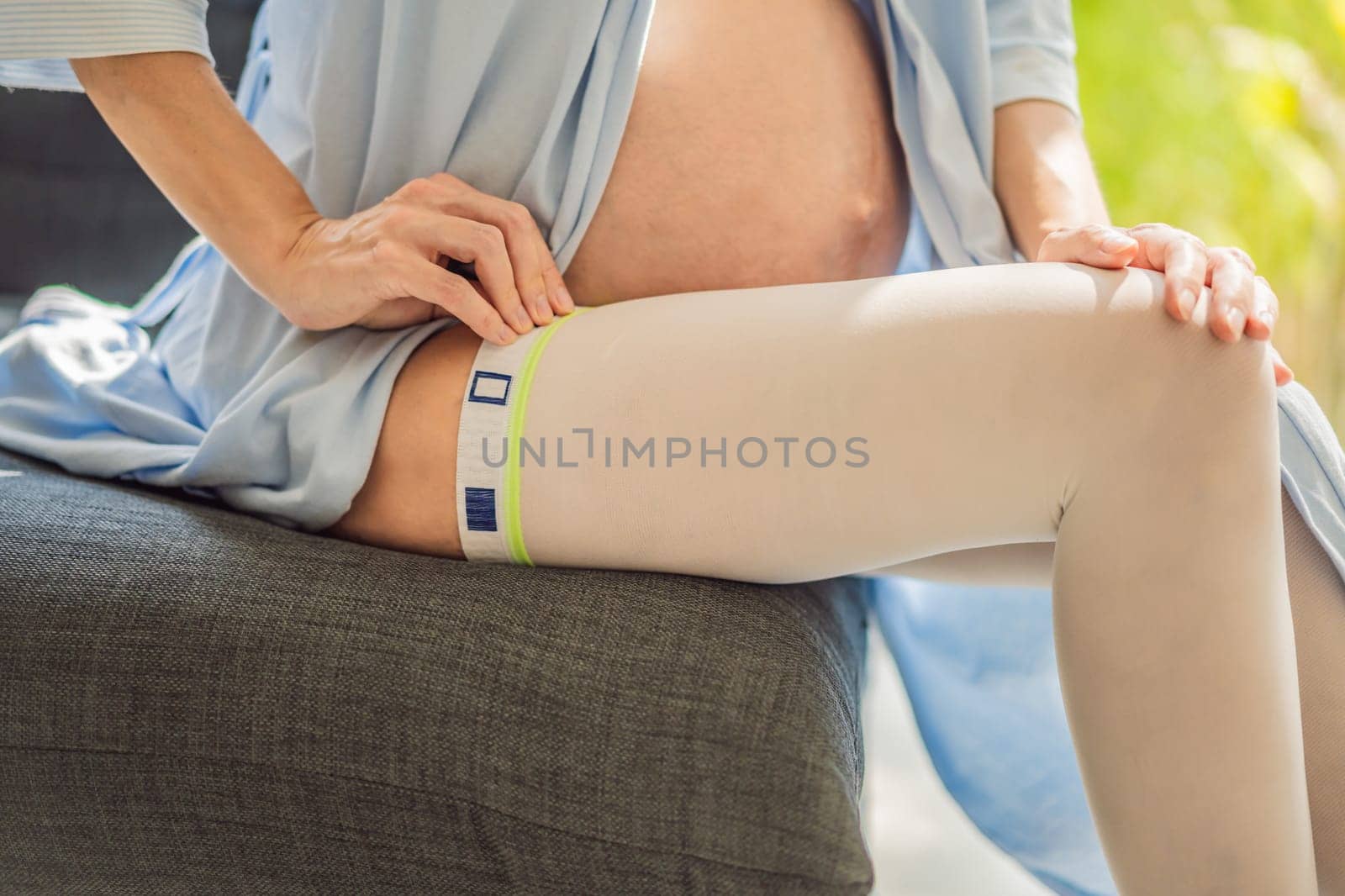 A content and comfortable pregnant woman wearing compression stockings, ensuring better leg health and support during her pregnancy journey.