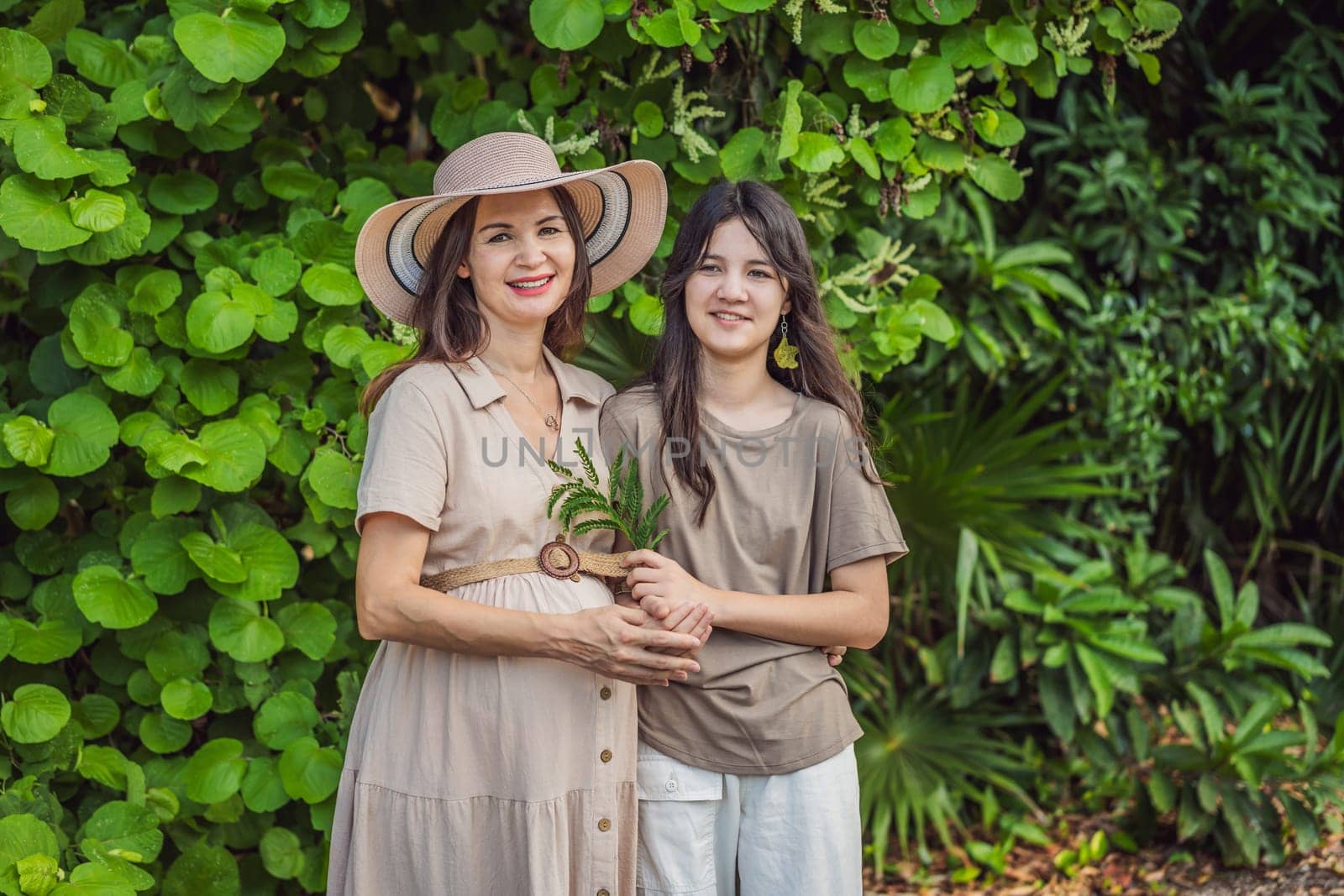 A heartwarming moment captured in the park as a pregnant woman after 40 shares a special bond with her teenage daughter, embracing the beauty of mother-daughter connection.