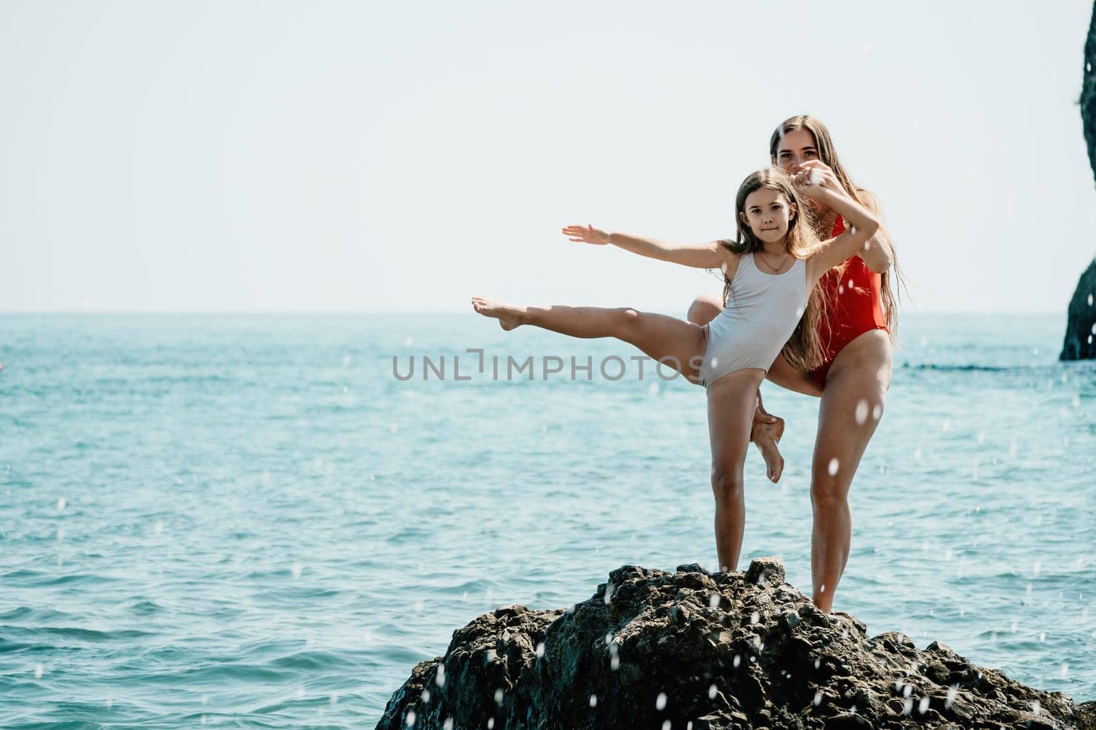 Silhouette mother and daughter doing yoga at beach. Woman on yoga mat in beach meditation, mental health training or mind wellness by ocean, sea