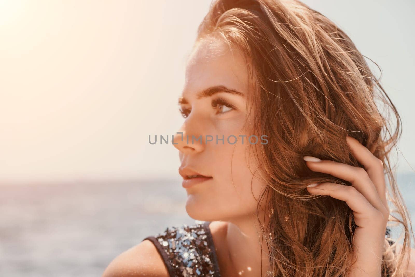 Woman summer travel sea. Happy tourist enjoy taking picture outdoors for memories. Woman traveler posing on the beach at sea surrounded by volcanic mountains, sharing travel adventure journey by panophotograph