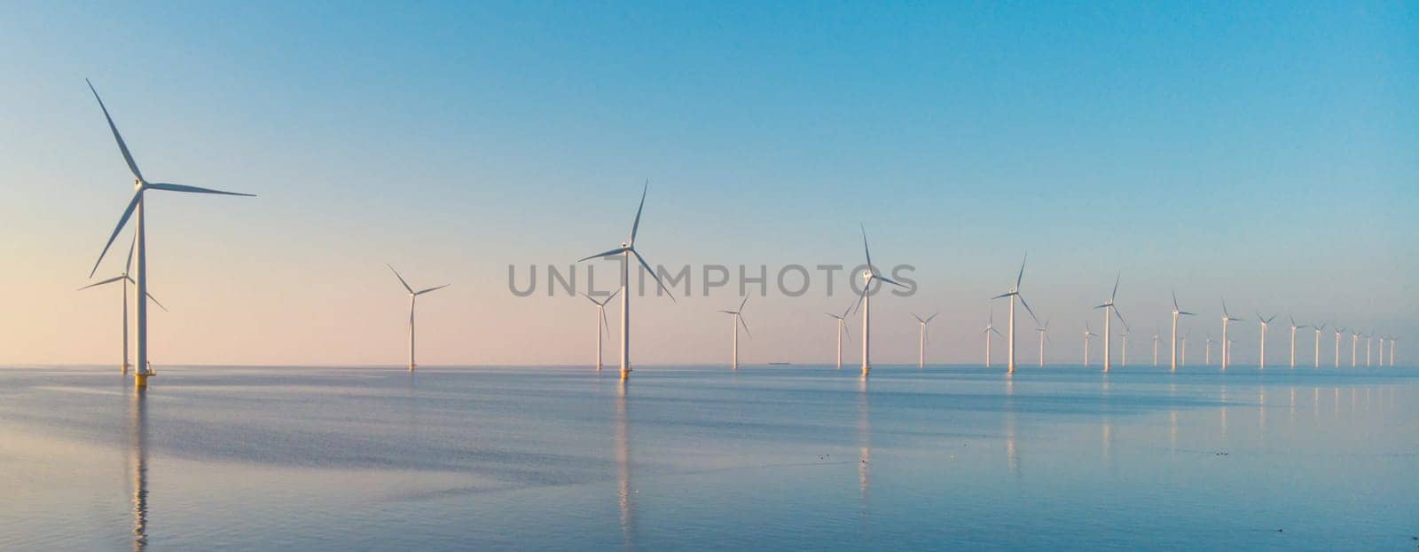 Windmill turbines at sea , drone aerial view from above at a huge winmill park in the Netherlands by fokkebok