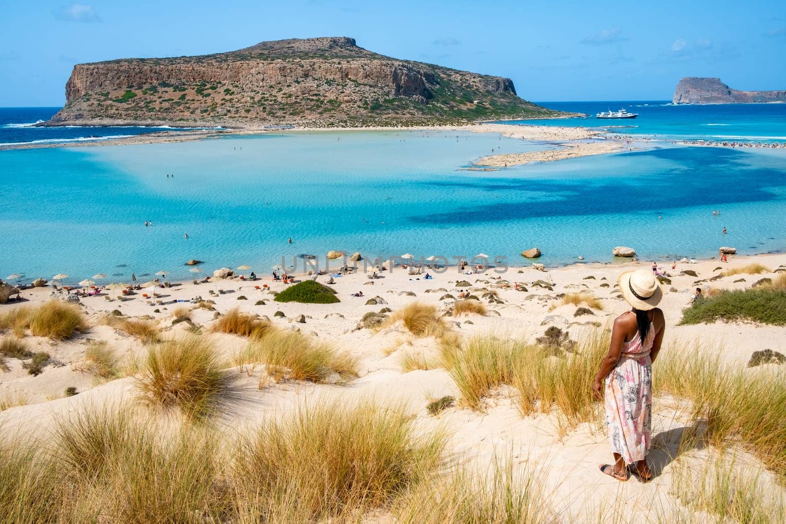 Crete Greece, Balos lagoon on Crete island, Greece. Tourists relax at the crystal clear ocean of Balos Beach. Greece, a Asian woman visit the beach during a vacation in Greece