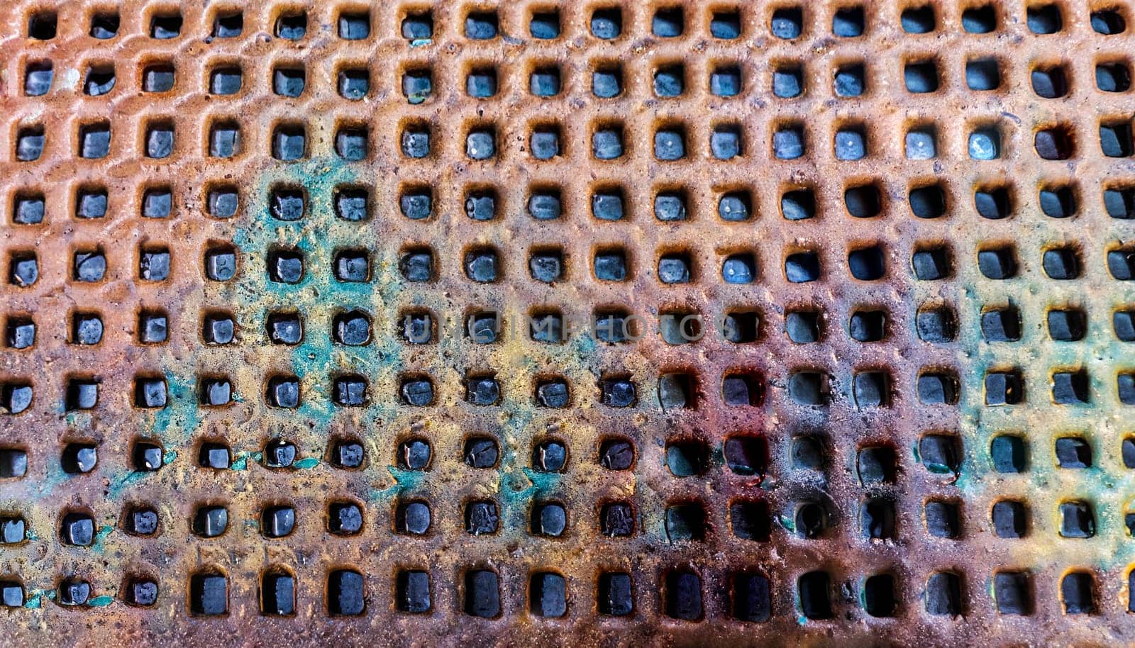 rusty metal grilles of an old sewer for water drainage. photo close-up, top view