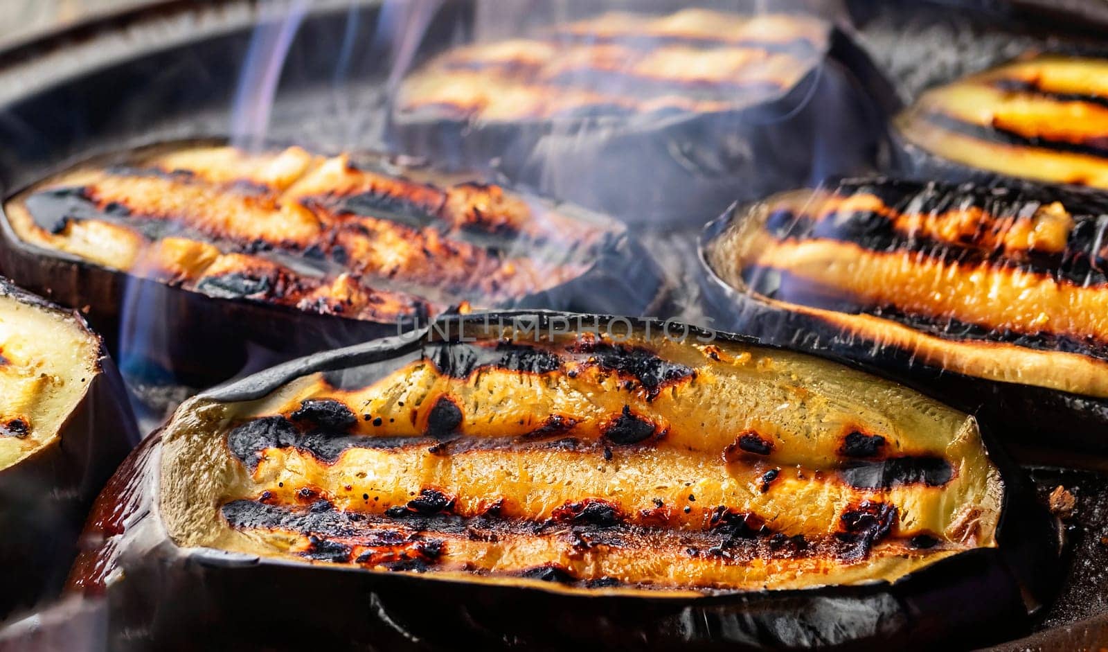 Eggplant on coals. Cooking charcoal closeup. Top view. Barbecue day, Grilled eggplants, concept healthy food