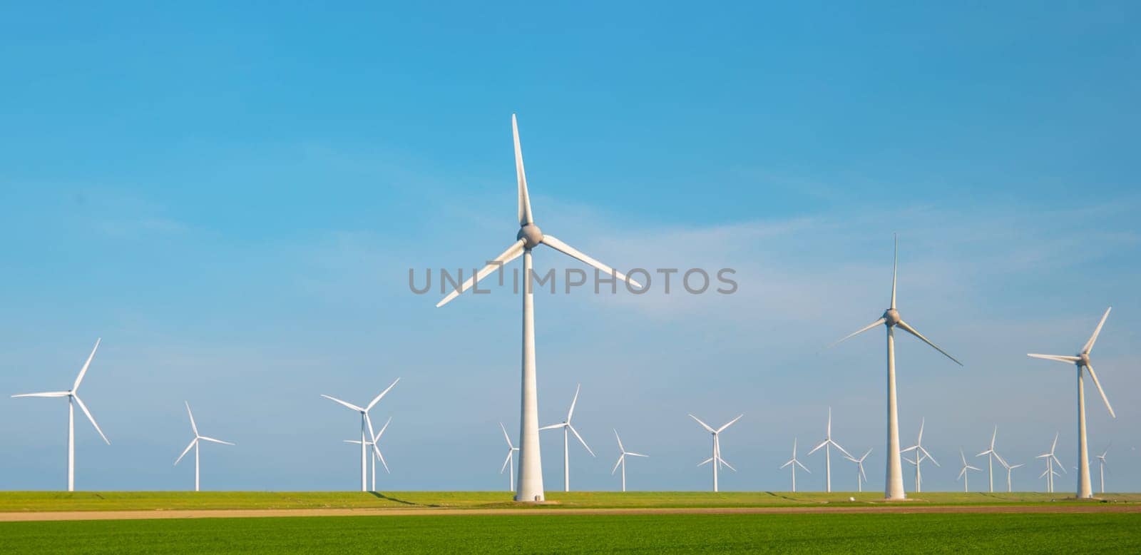 Windmill park with clouds and a blue sky, windmill park in the ocean aerial view with wind turbine Flevoland Netherlands Ijsselmeer. Green Energy production in the Netherlands