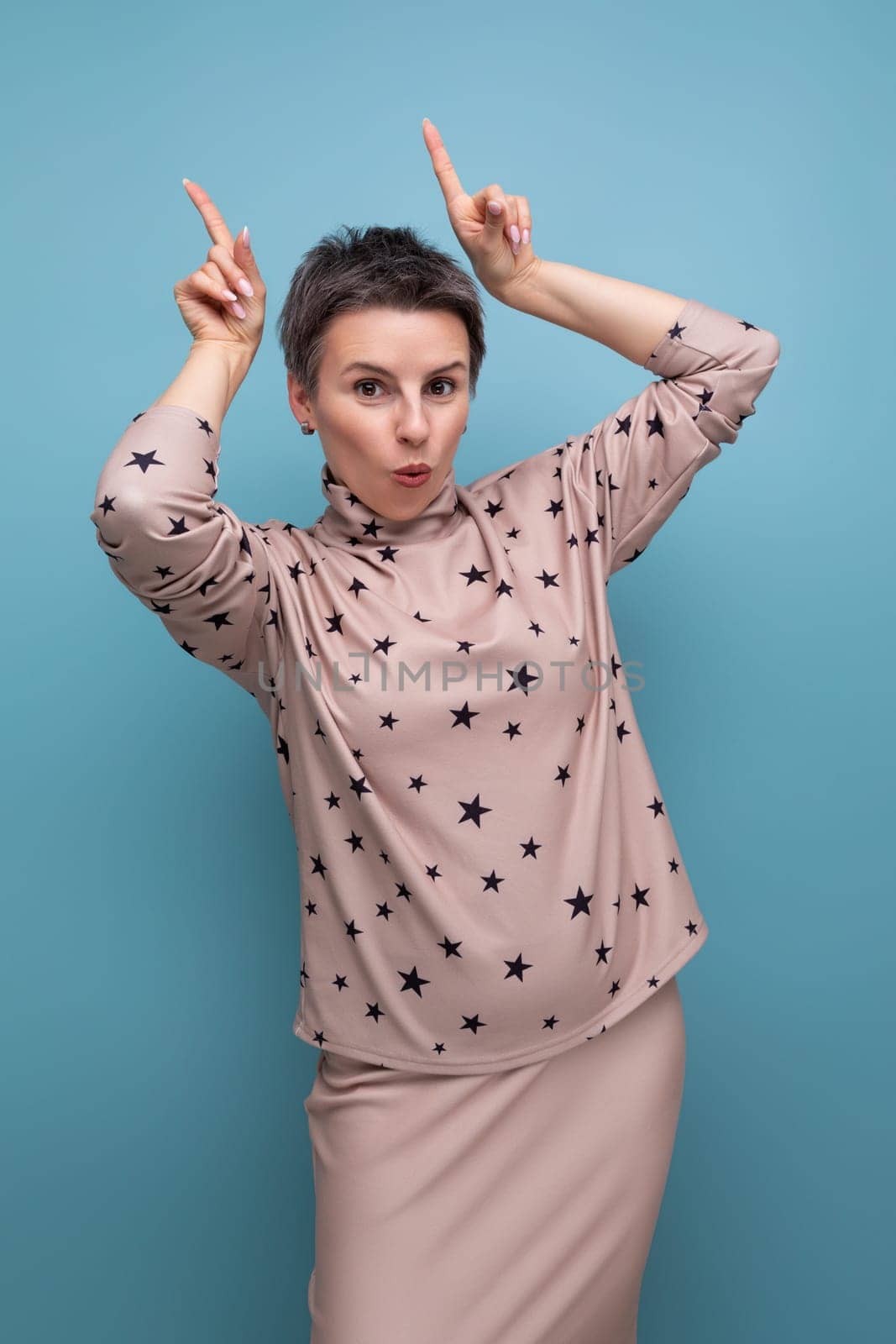 a pretty young caucasian dark-haired lady in a short-haired skirt and blouse tells interesting news.