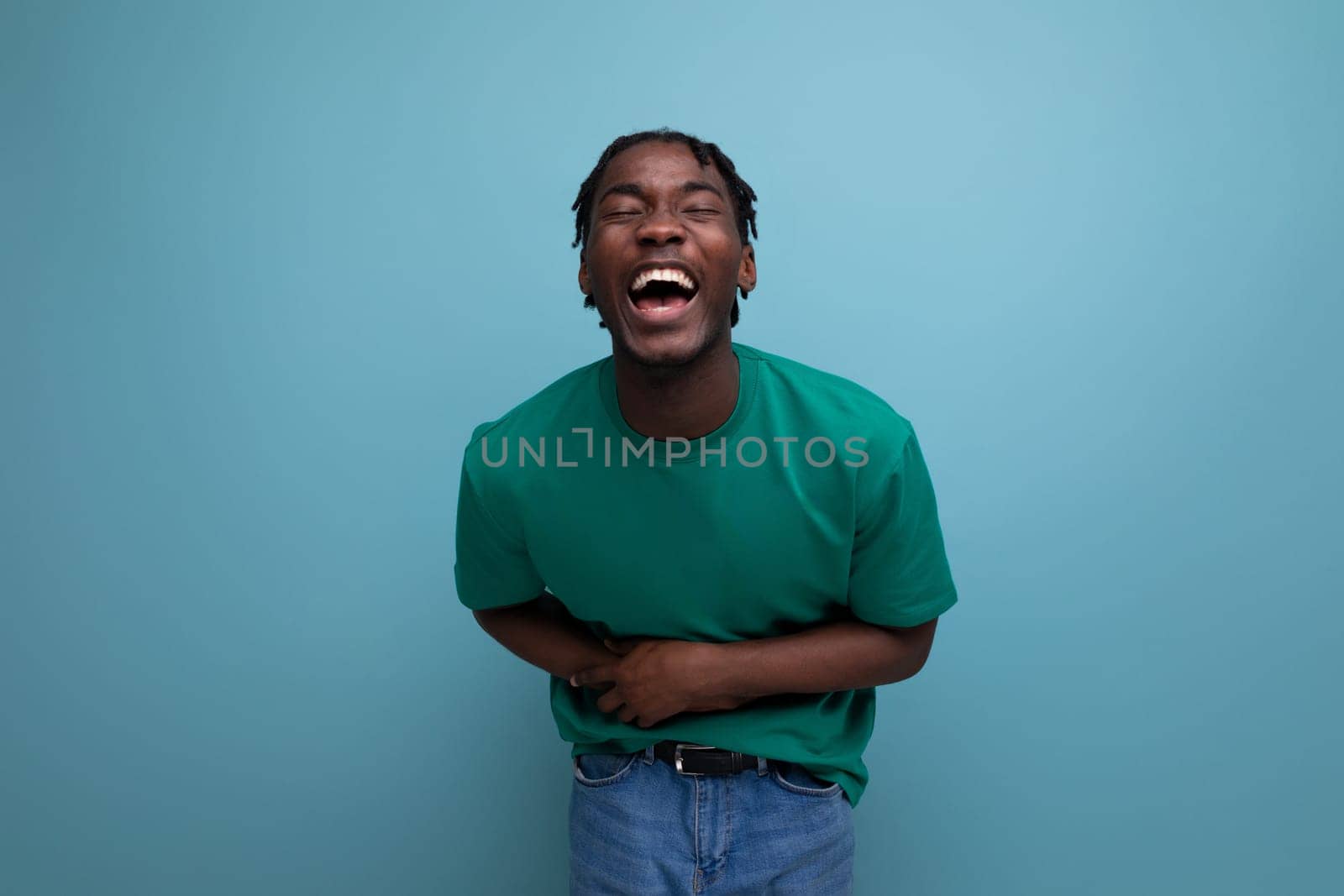 funny laughing american young guy in a t-shirt on a blue background by TRMK