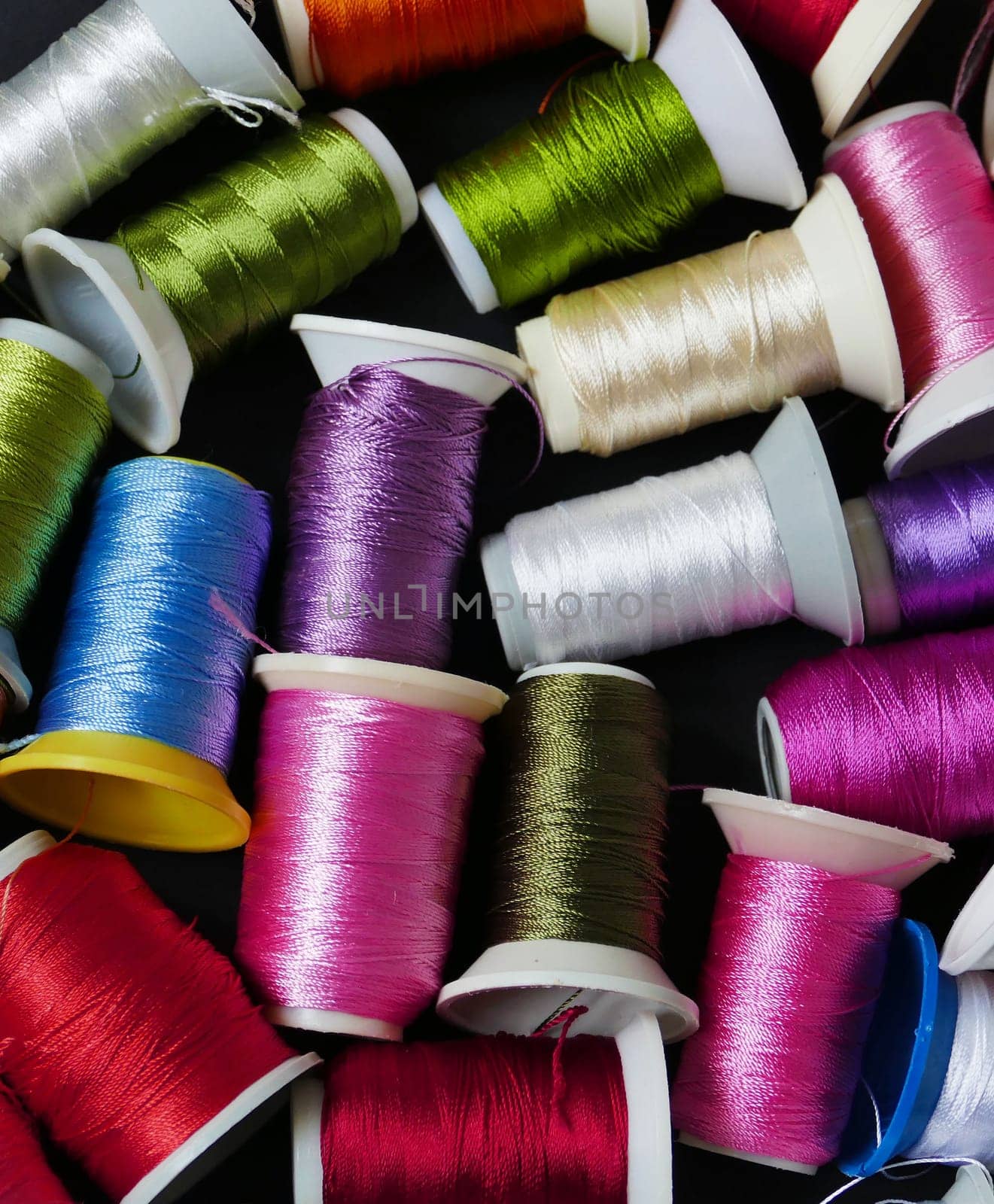 close-up colorful threads,craft threads,colorful lace knitting threads wound on spools,