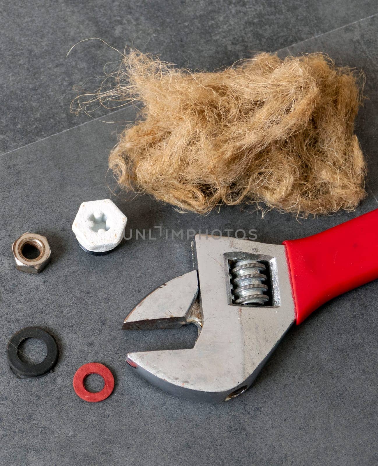 on the floor- there are wrench and plumbing linen- water seals- and water plug- close-up