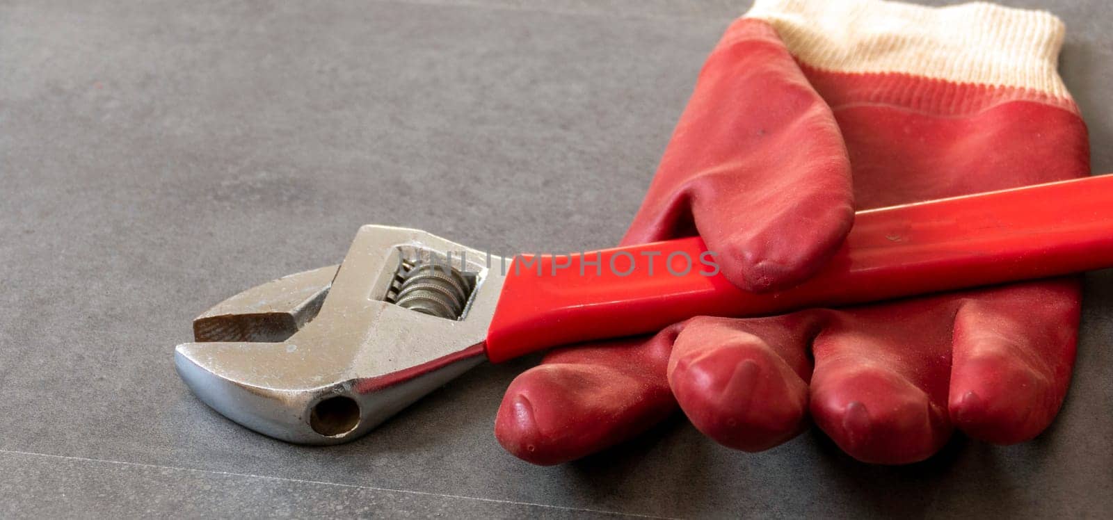 For work safety, it is necessary to work with gloves, a wrench, thick plastic gloves are standing on a floor, by nhatipoglu