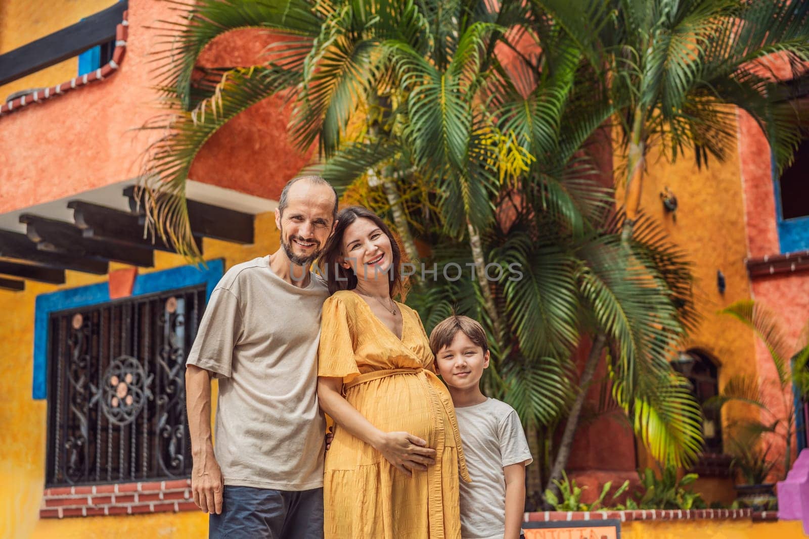 A loving couple in their 40s and their teenage son cherishing the miracle of childbirth in Mexico, embracing the journey of parenthood with joy and anticipation by galitskaya