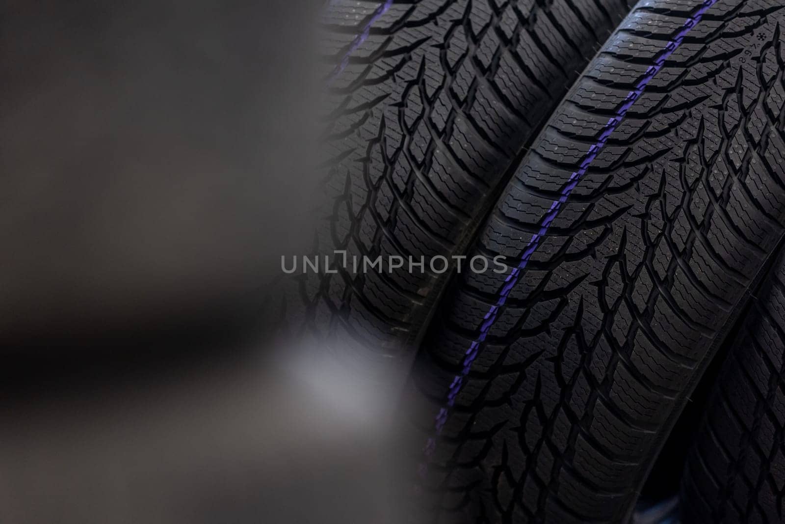 Close up of new winter tires for the cold season, vehicle service concept by Kadula