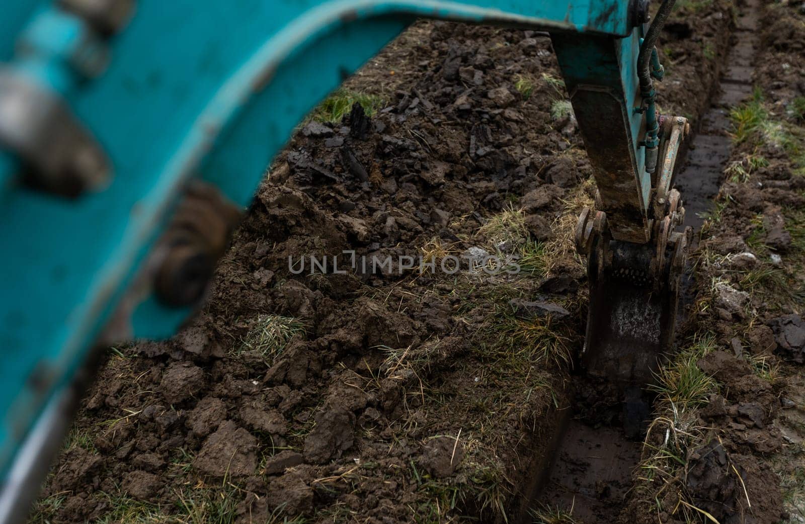 Close up of excavator or digger digging some a soil or clay, industrial concept by Kadula