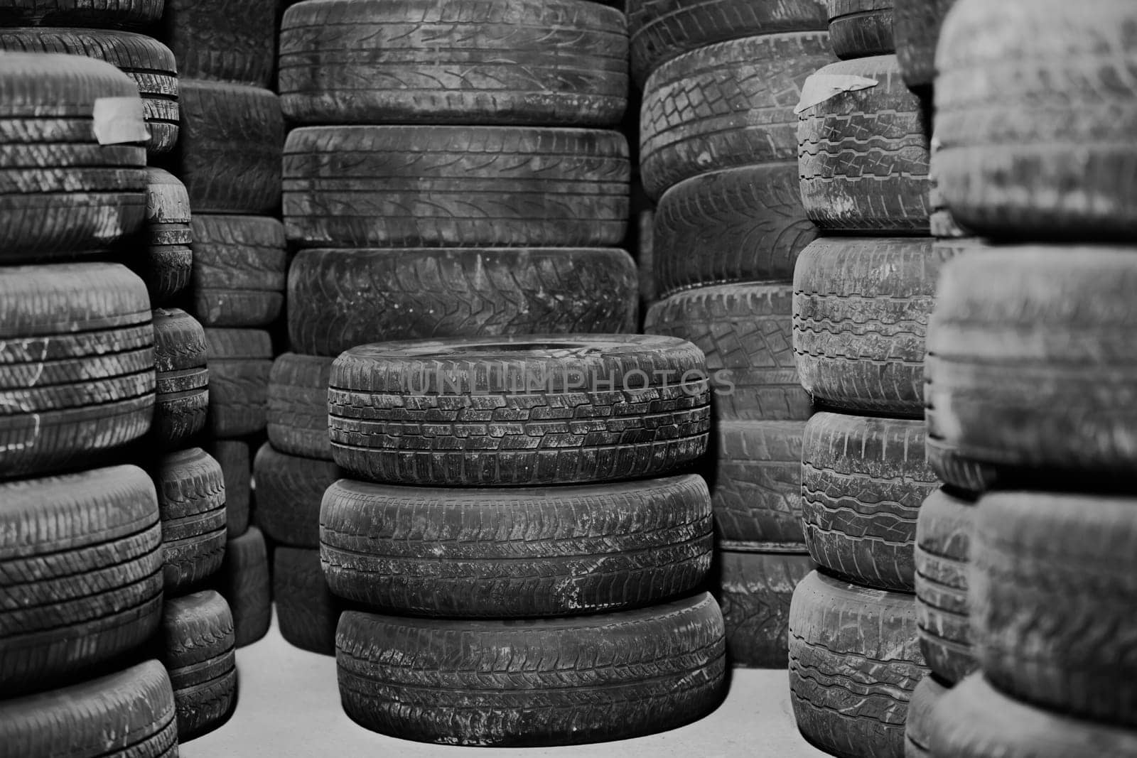 Worn out or used car tires in the warehouse, service center, stored tires, transportation concept