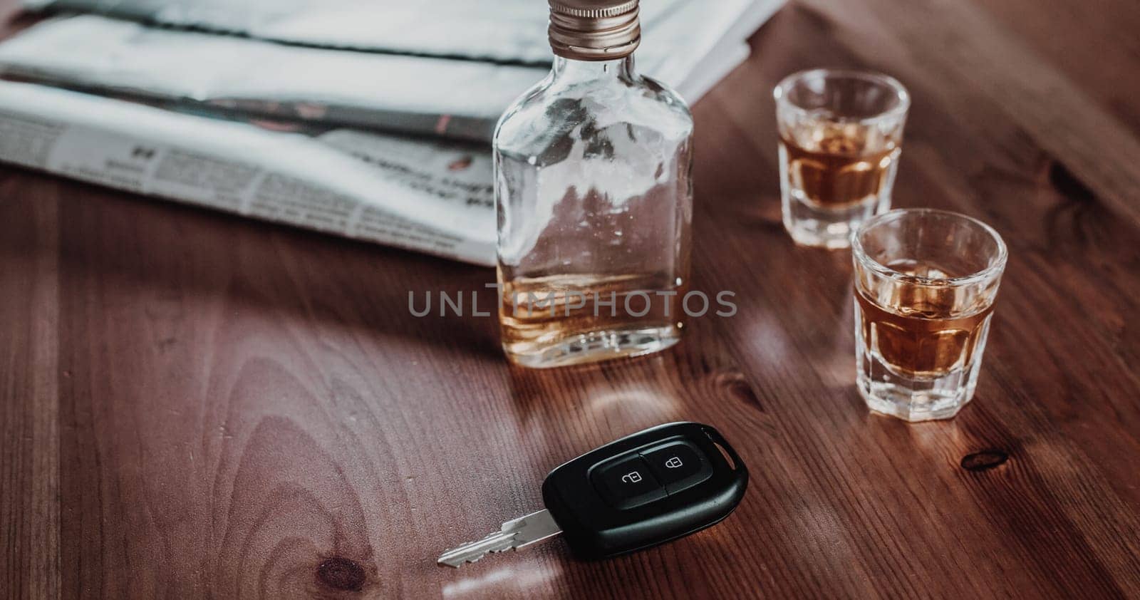 Do not drink and drive concept, Close up of car keys and glass of strong alcohol rum, driving concept, beware of alcohol