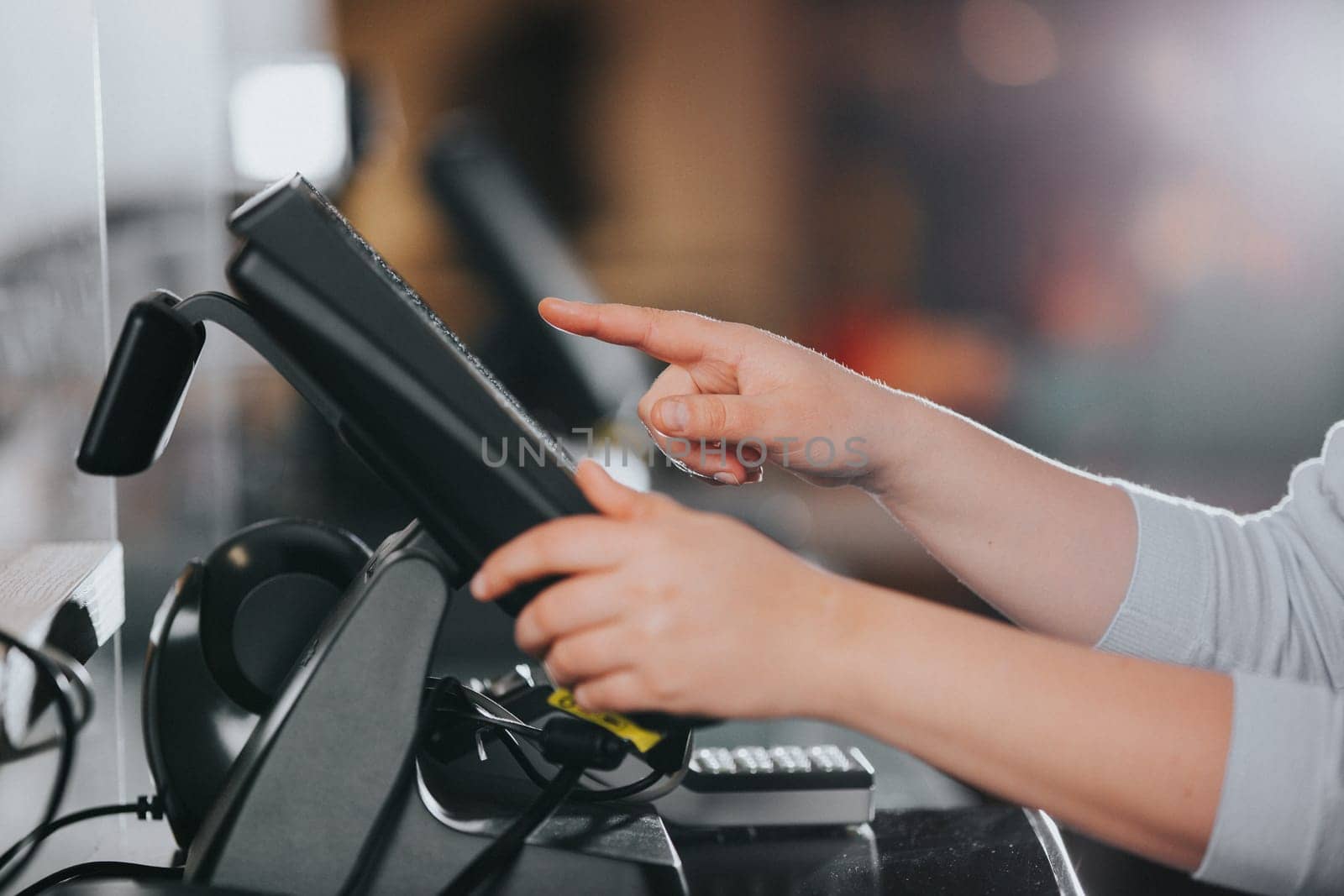 POS concept, young woman hand doing process payment on the touchscreen cash register, finance, shopping concept