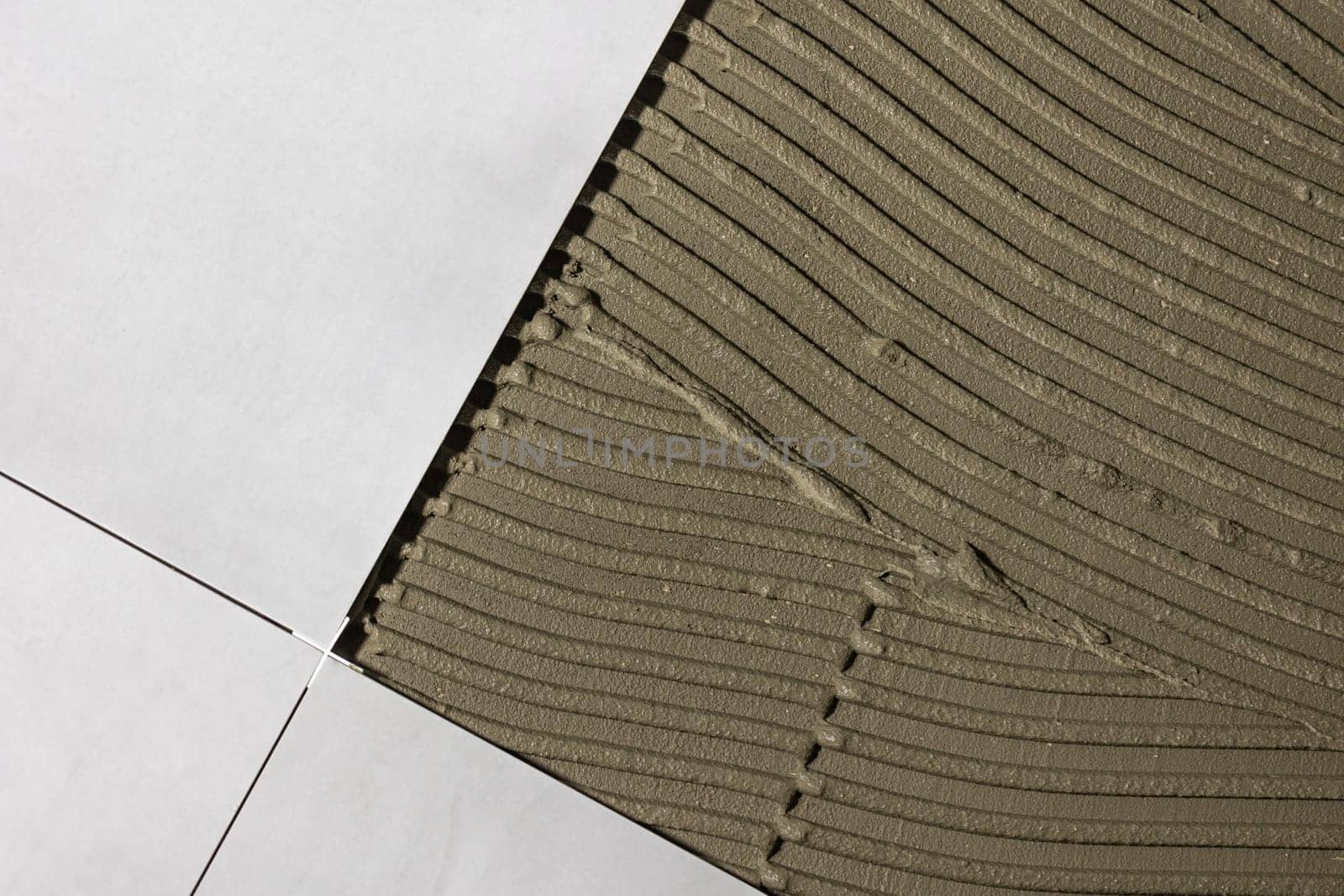 Detail of clips or spacers in the lash tile leveling system, renovation or reconstruction concept by Kadula