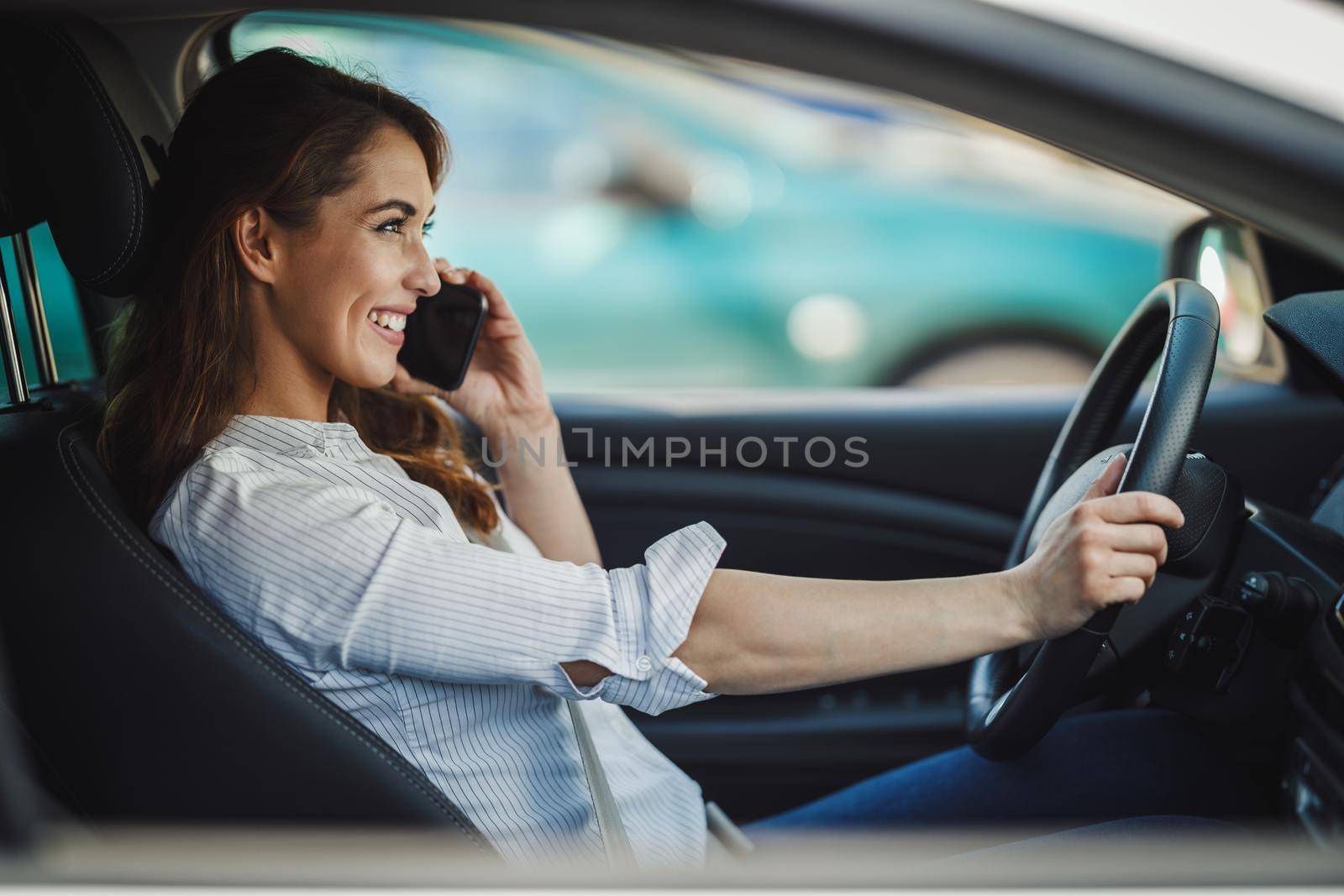 Shot of an attractive businesswoman talking on a smartphone during her morning commute.