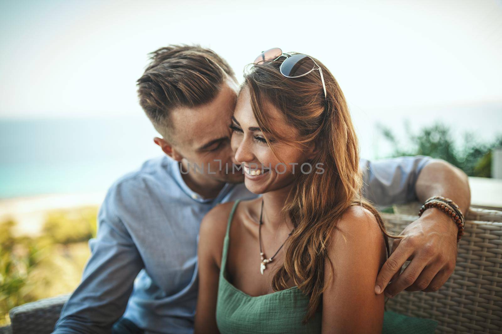 A beautiful young couple is having fun while spending time in a Mediterranean town. They are enjoying in summer sunny day,