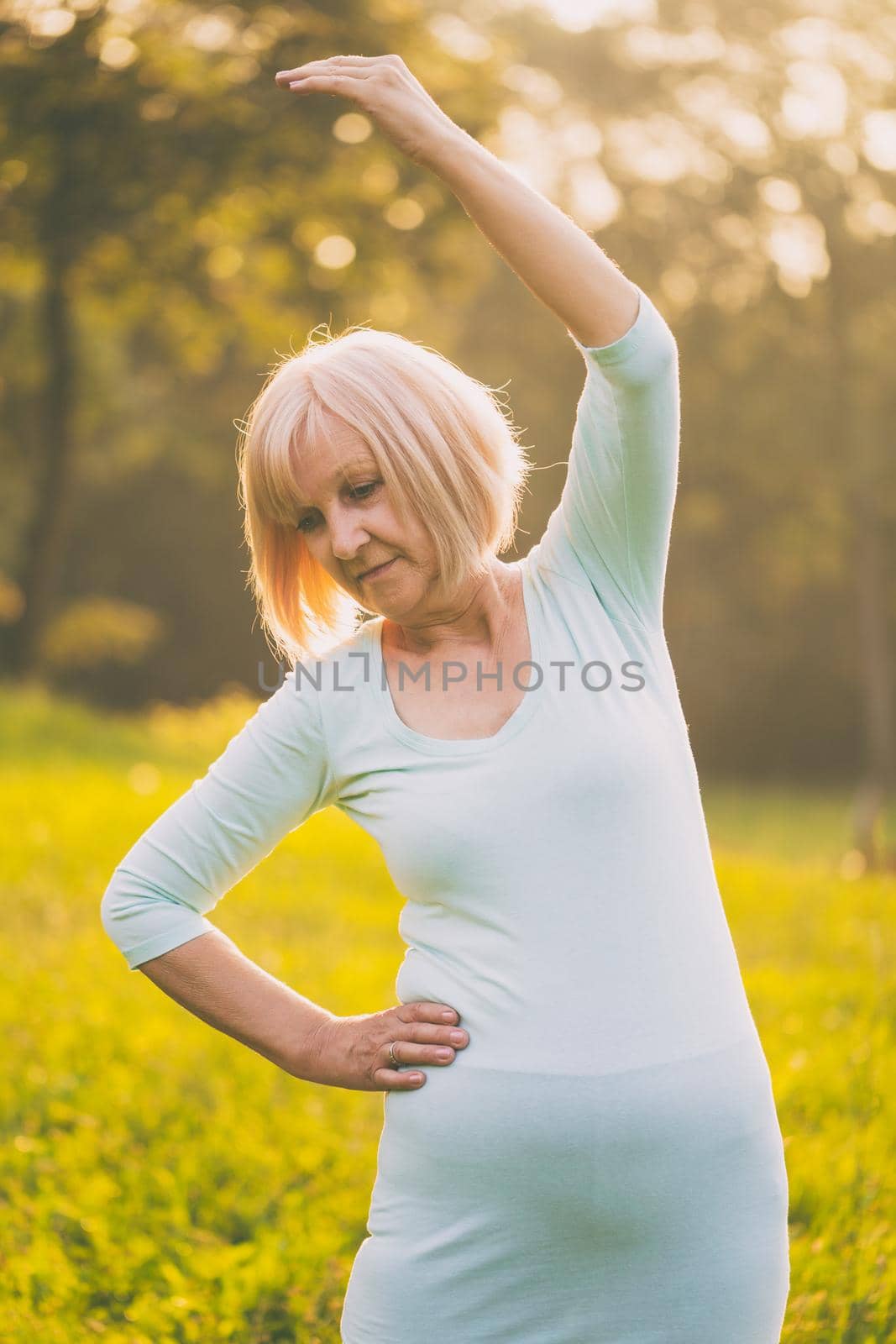 Sporty senior woman exercising outdoor.