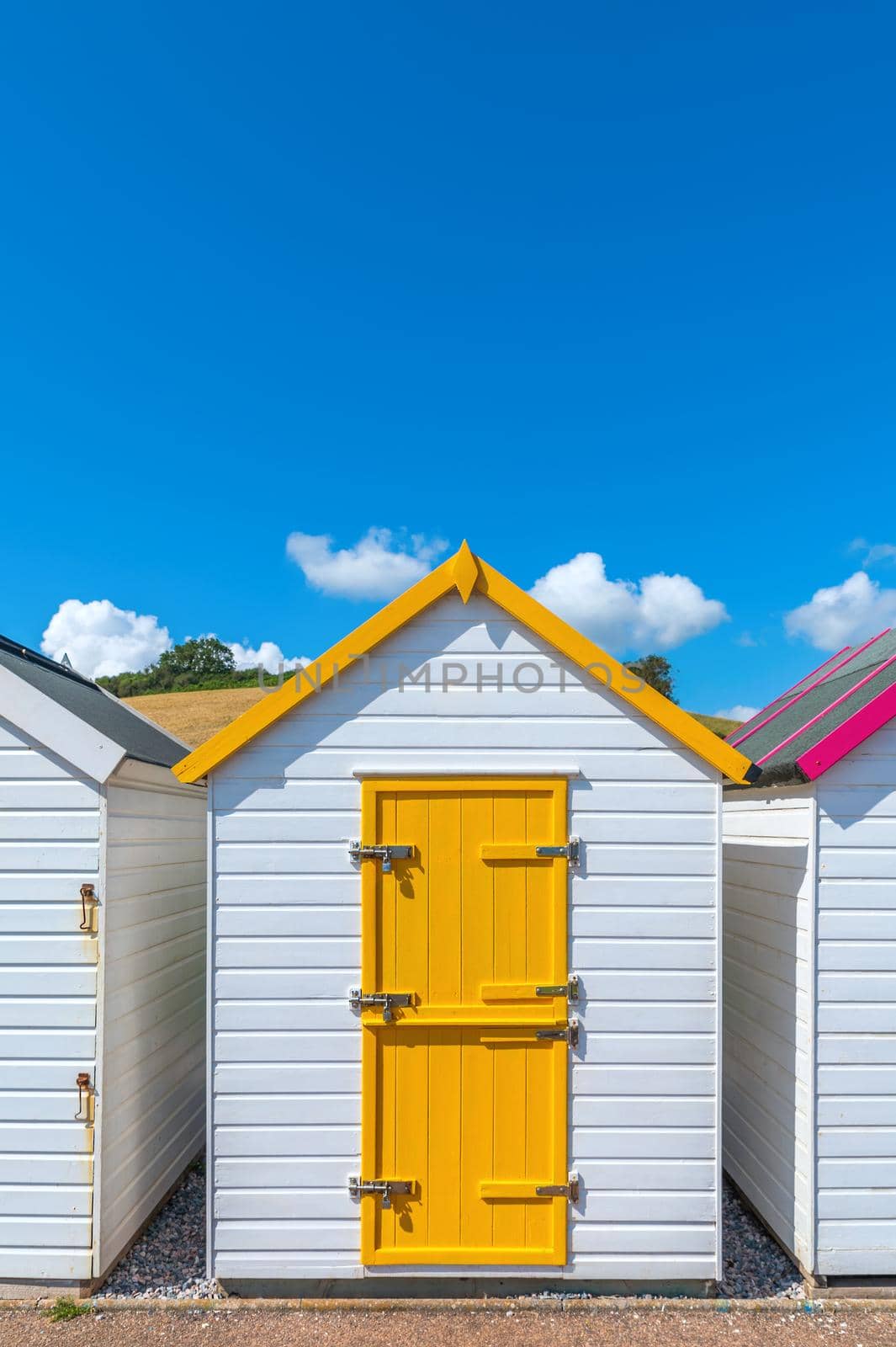 Colorfully painted door of small beach house. Multicolored beach shed. Variety of painted beach shack. Beach hut. Torbay, South Devon. UK. by Qba