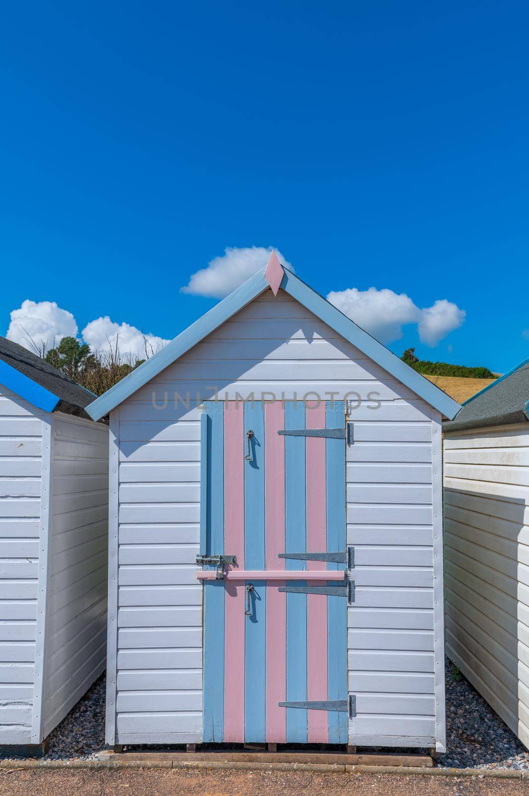 Colorfully painted door of small beach house. Multicolored beach shed. Variety of painted beach shack. Beach hut. Torbay, South Devon. UK. by Qba