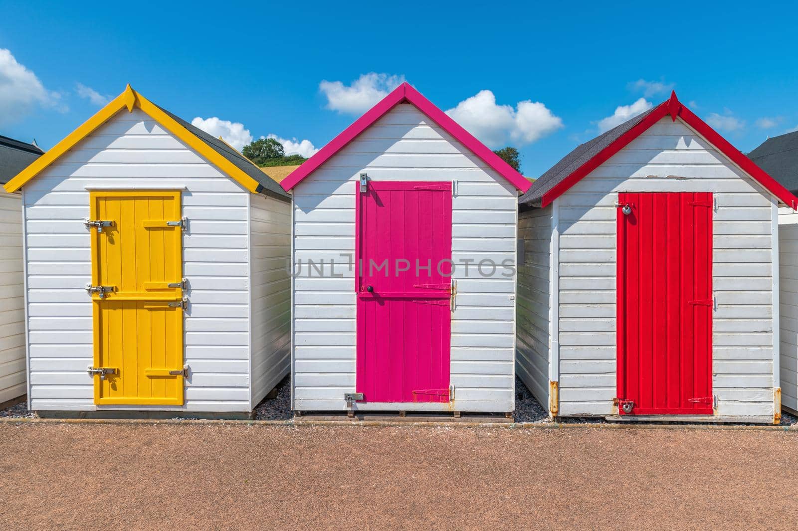 Colorful small beach houses. Multicolored beach sheds. Variety of painted beach shacks. Beach huts. Torbay, South Devon. UK. by Qba
