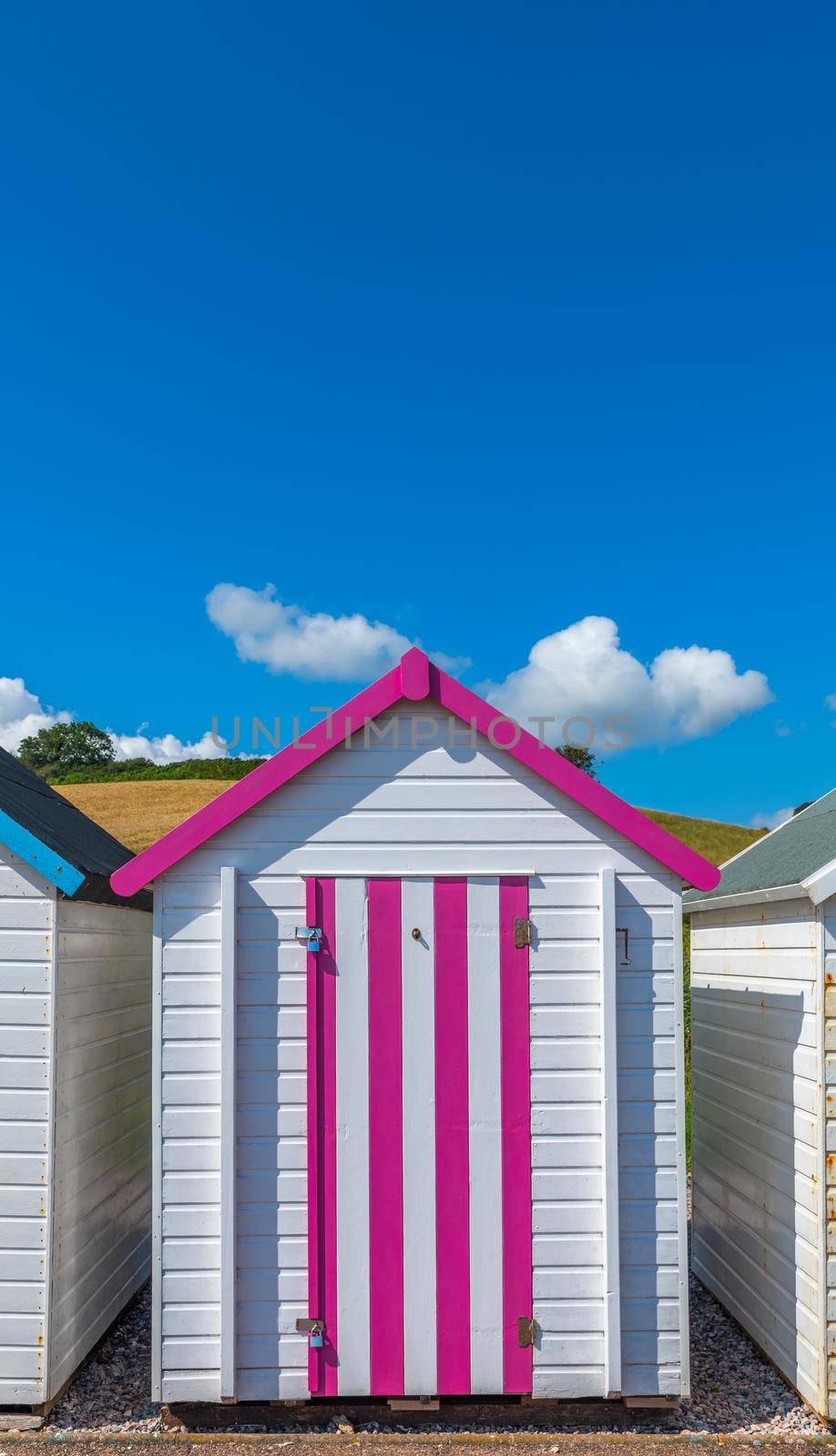 Colorfully painted door of small beach house. Multicolored beach shed. Variety of painted beach shack. Beach hut. Torbay, South Devon. UK. by Qba