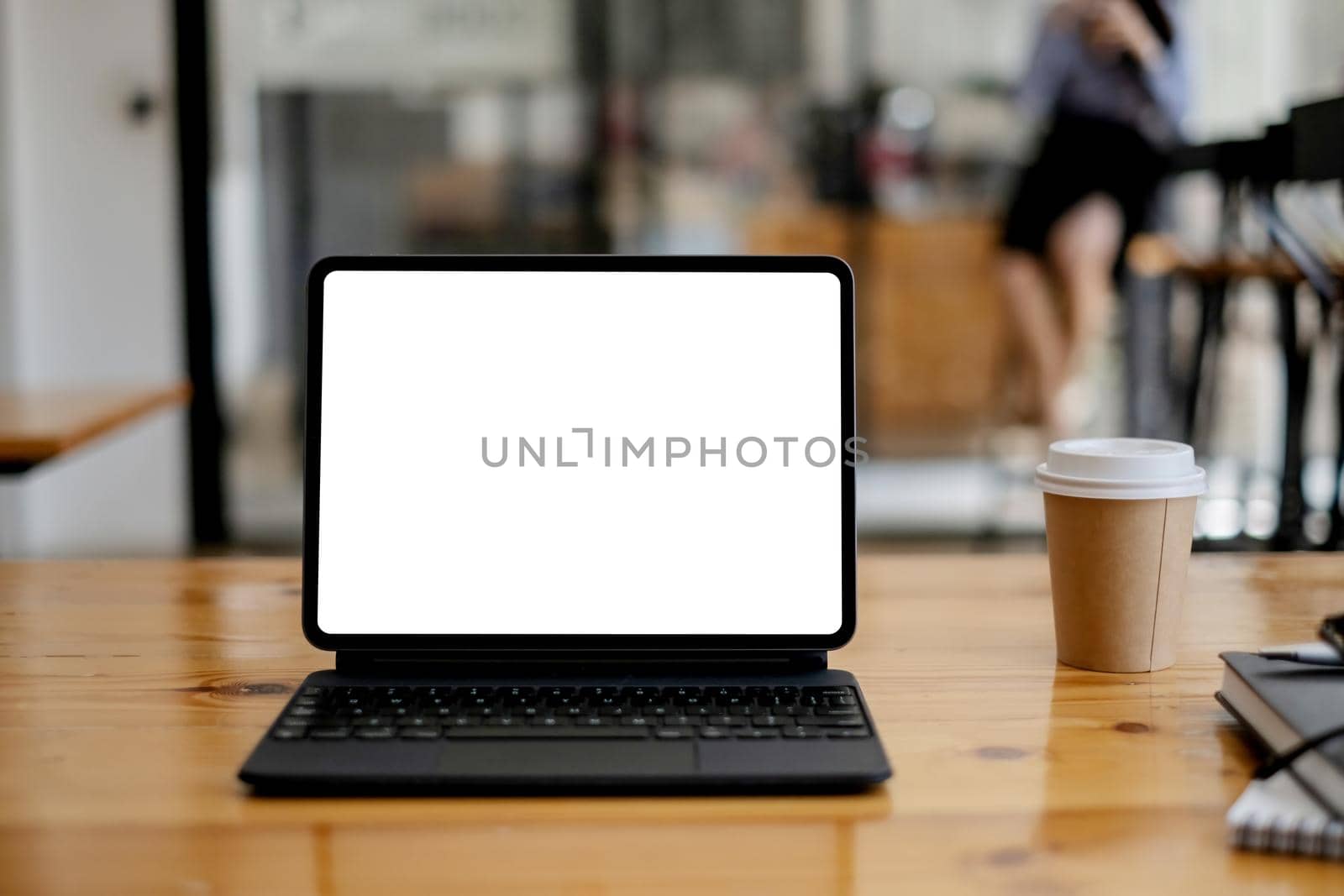 Image of Mock up digital tablet on wooden desk in office