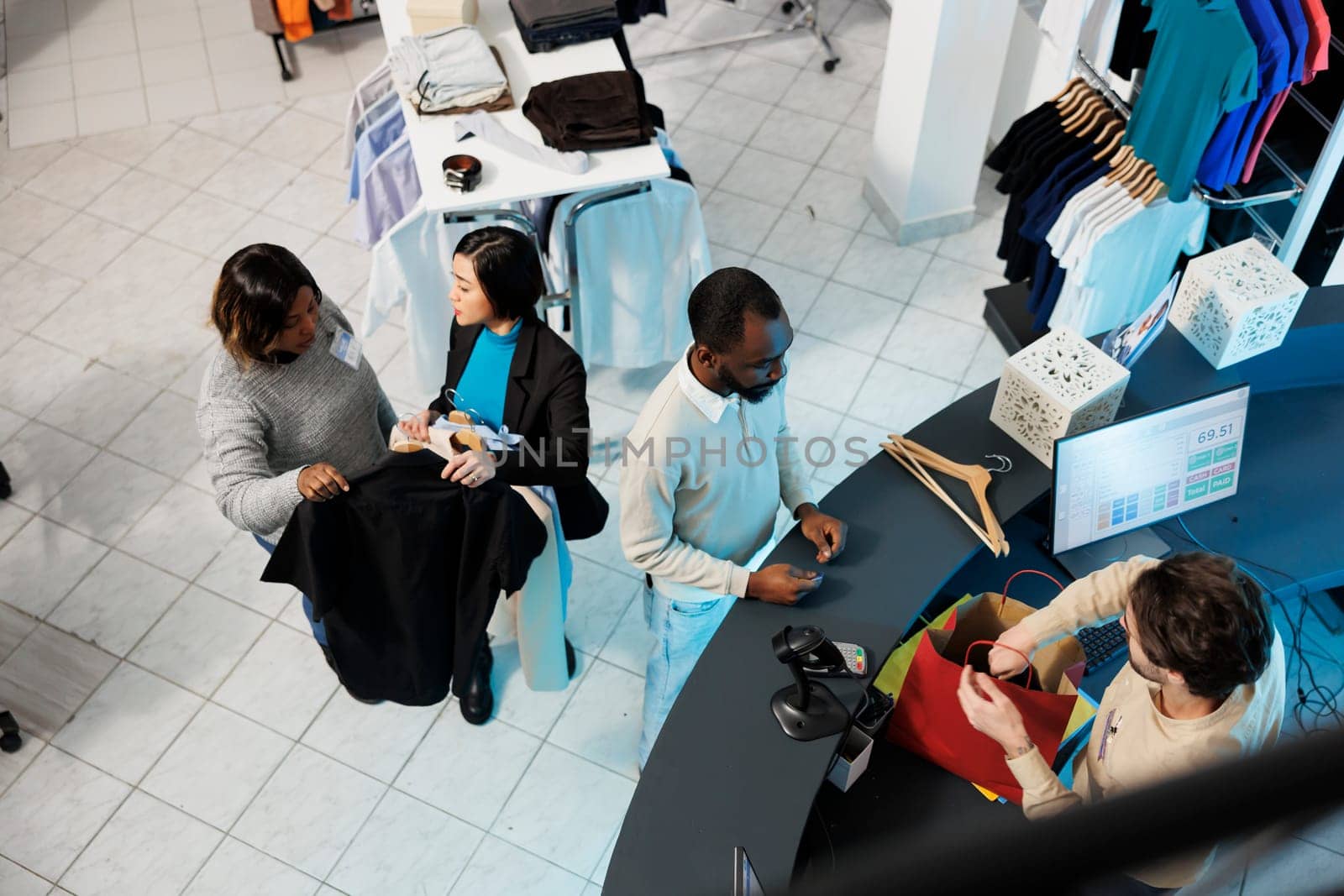 Customers waiting at checkout desk by DCStudio