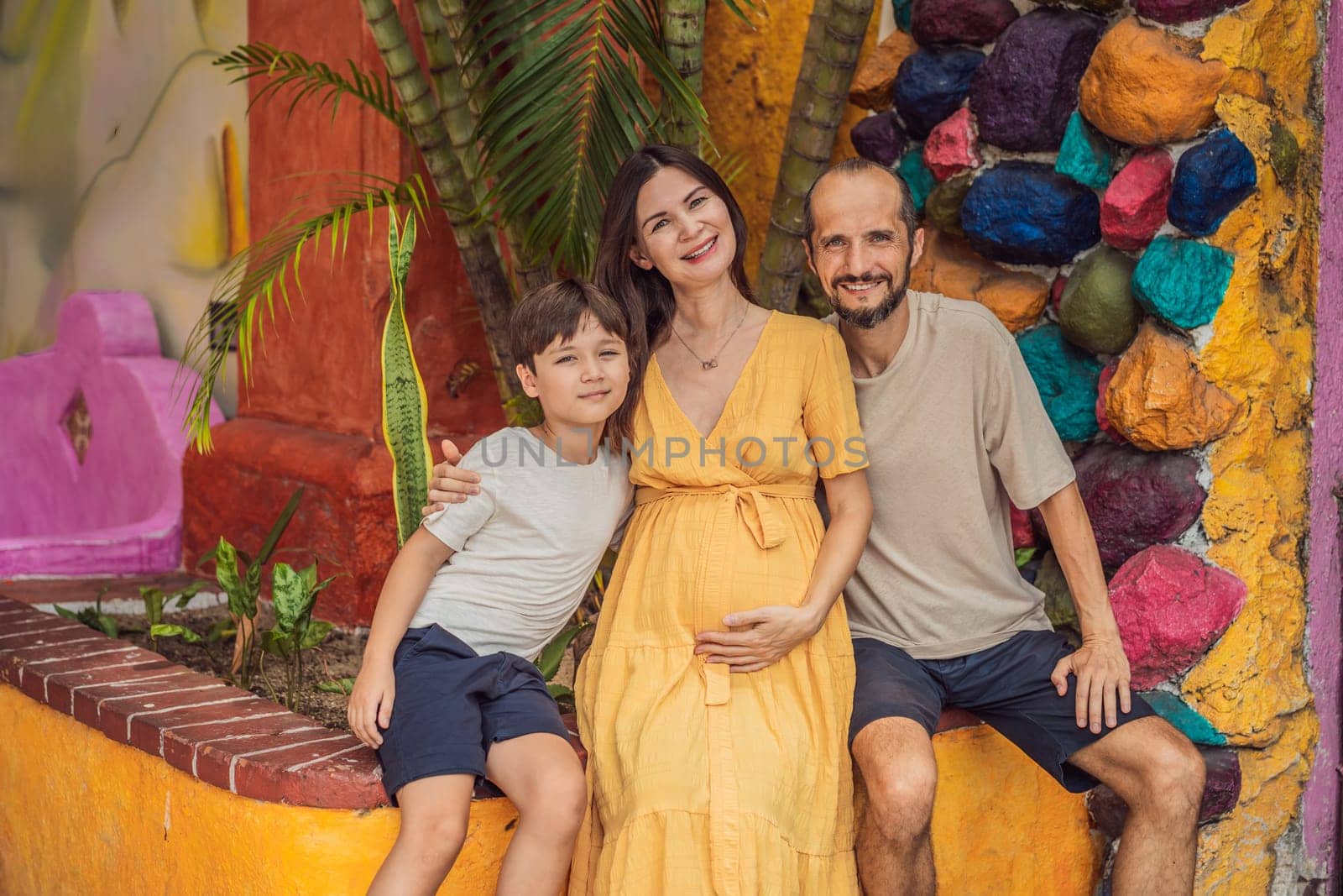 A loving couple in their 40s and their teenage son cherishing the miracle of childbirth in Mexico, embracing the journey of parenthood with joy and anticipation.