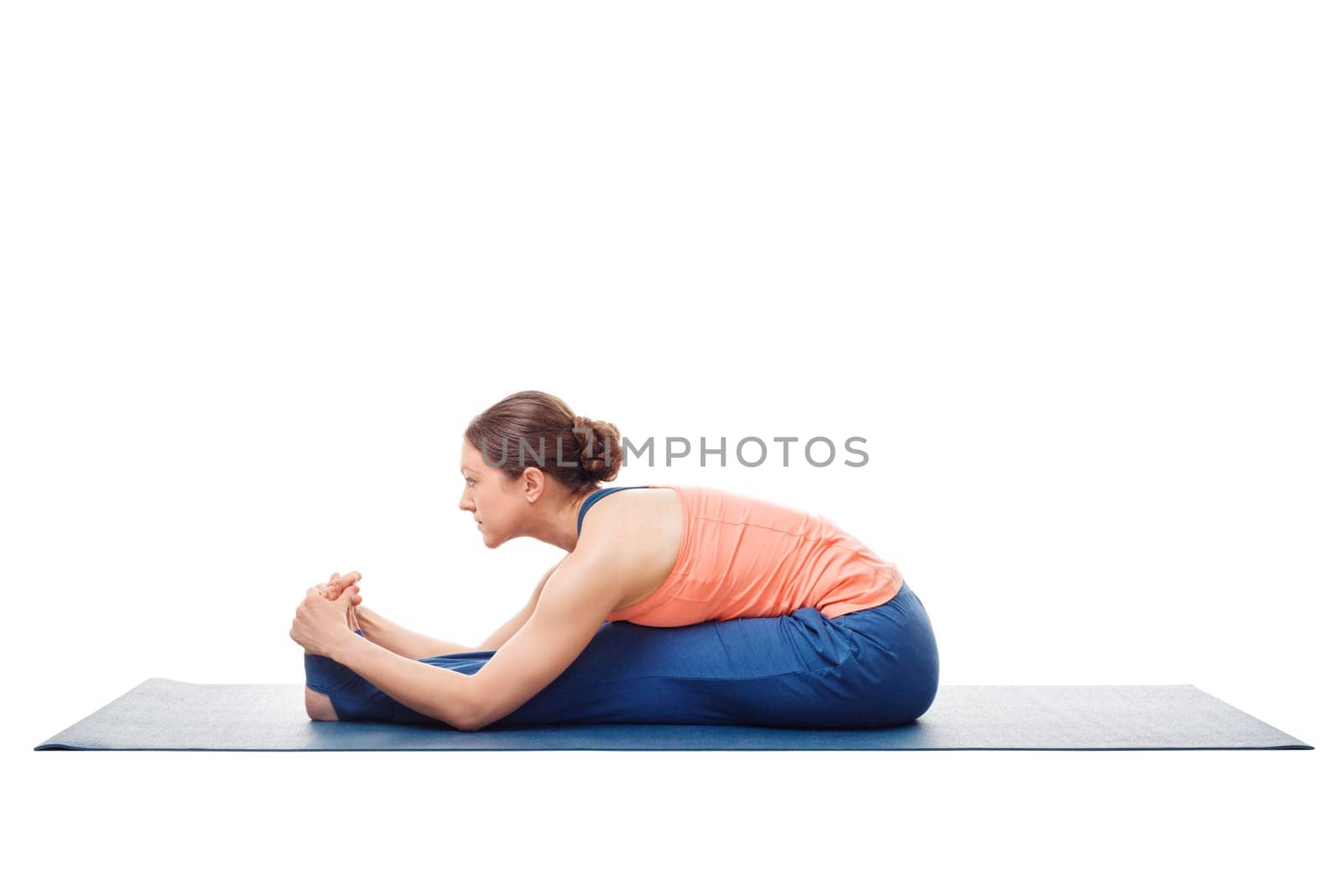 Sporty fit woman doing Ashtanga Vinyasa yoga back bending asana Paschimottanasana - seated forward bend isolated on white