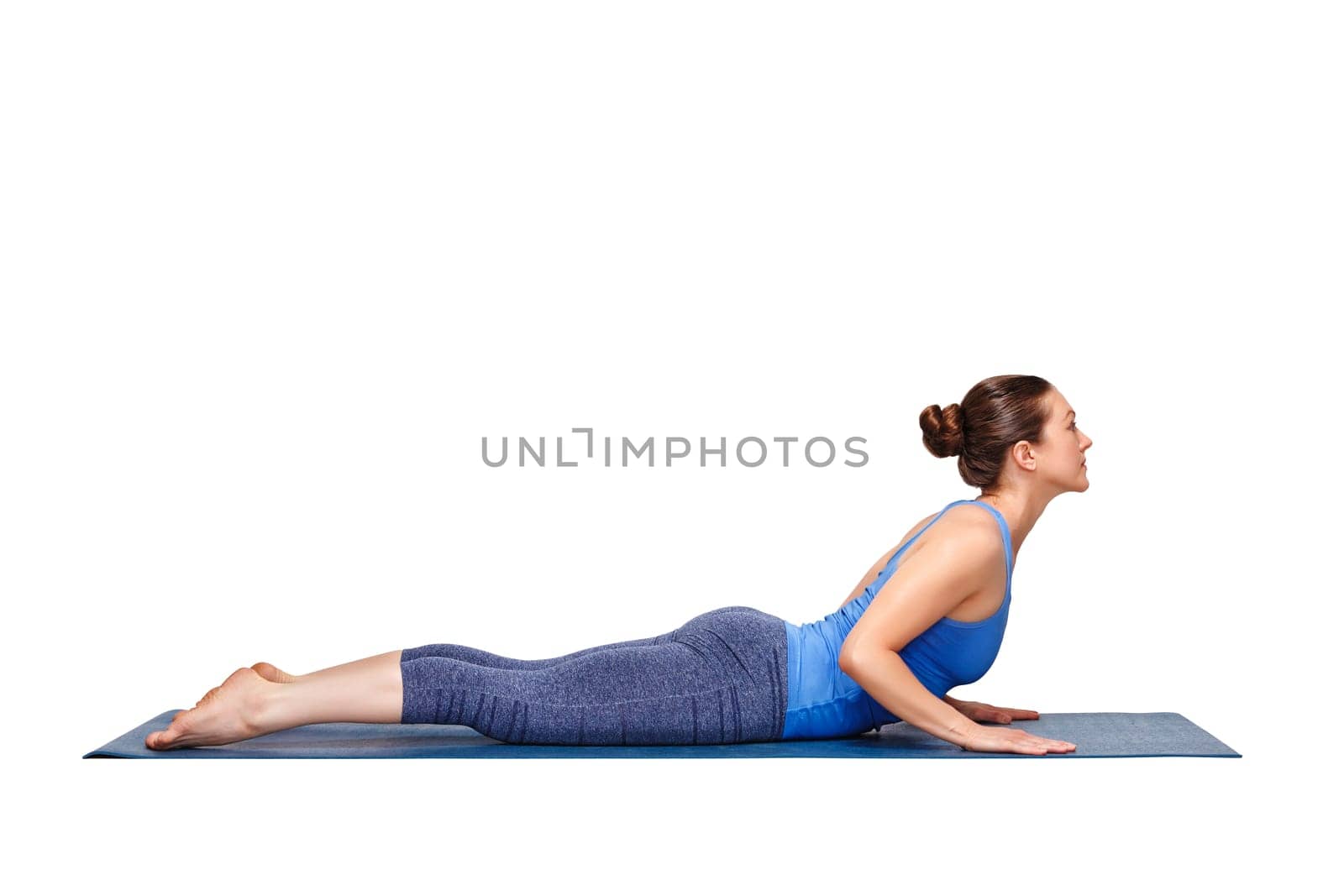 Beautiful sporty fit yogini woman practices yoga asana bhujangasana - cobra pose beginner variation in studio isolated on white