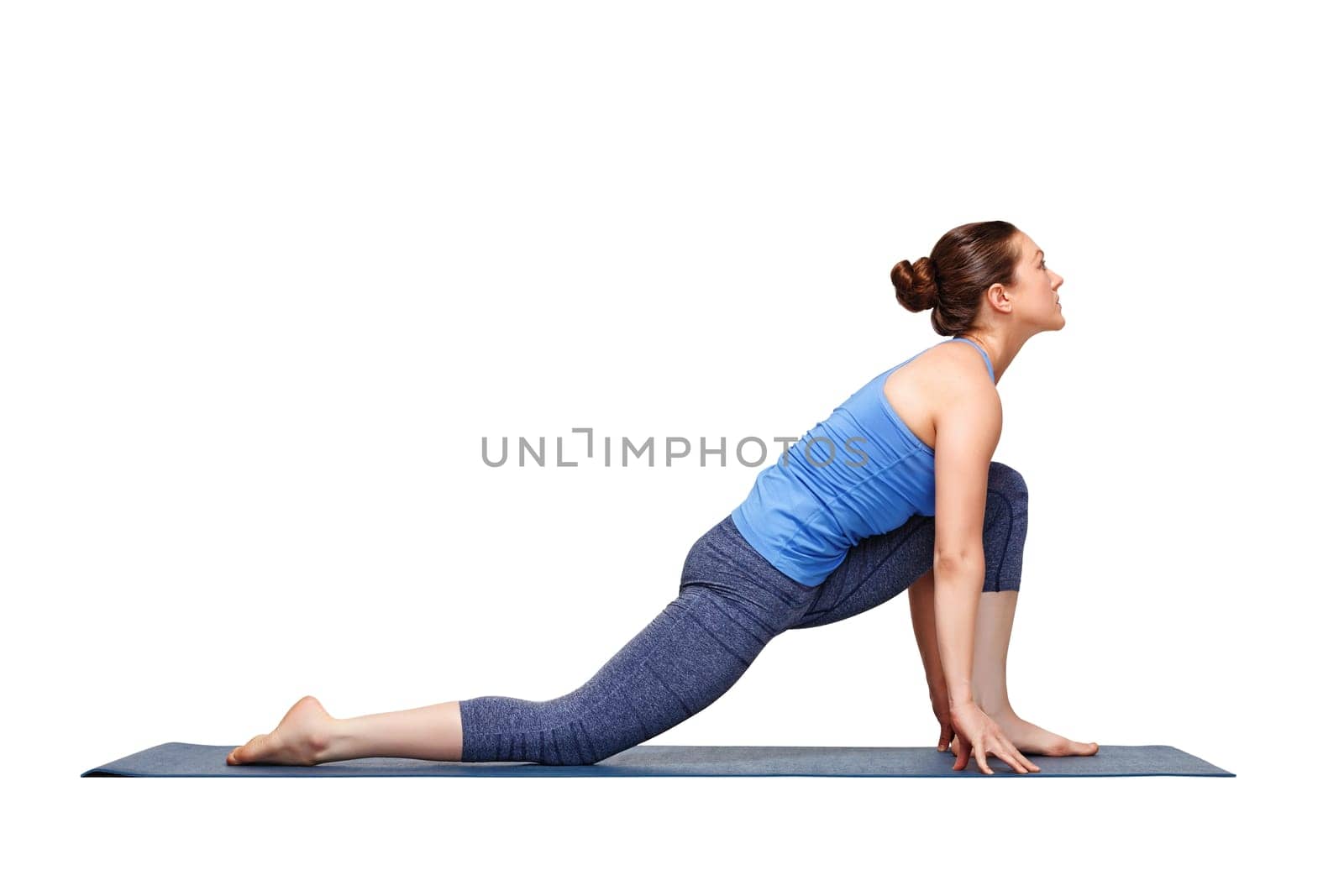 Beautiful sporty fit yogini woman practices yoga asana Anjaneyasana - low crescent lunge pose variation in surya namaskar in studio isolated on white