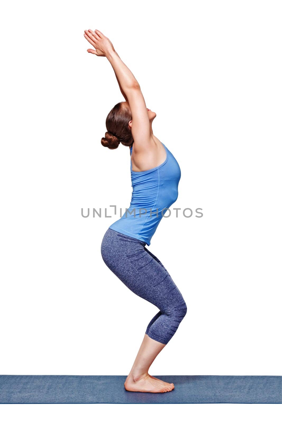 Sporty fit woman doing Surya Namaskar ashtanga vinyasa yoga asana Utkatasana - chair pose isolated on white