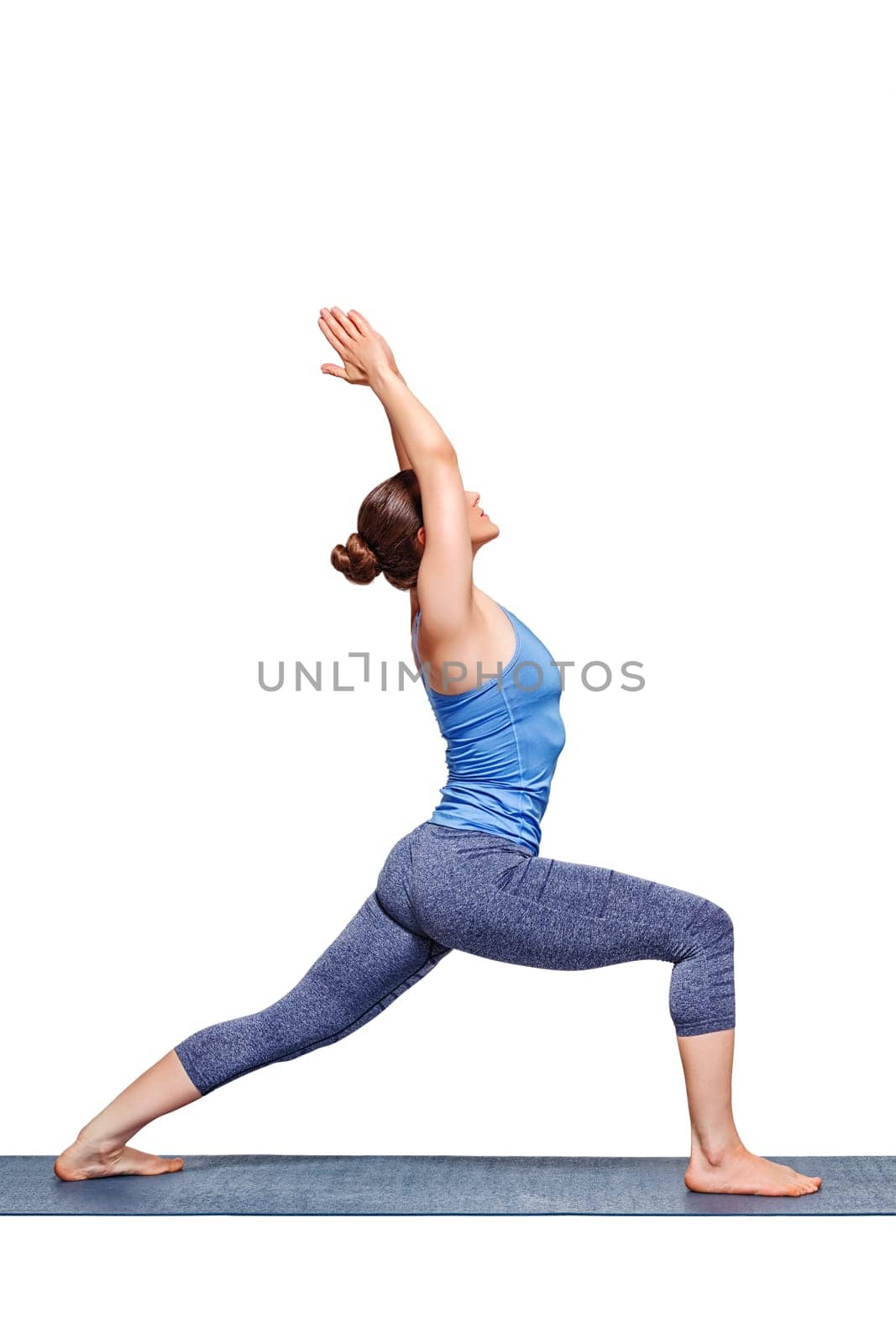 Sporty fit yogini woman practices yoga asana utthita Virabhadras by dimol