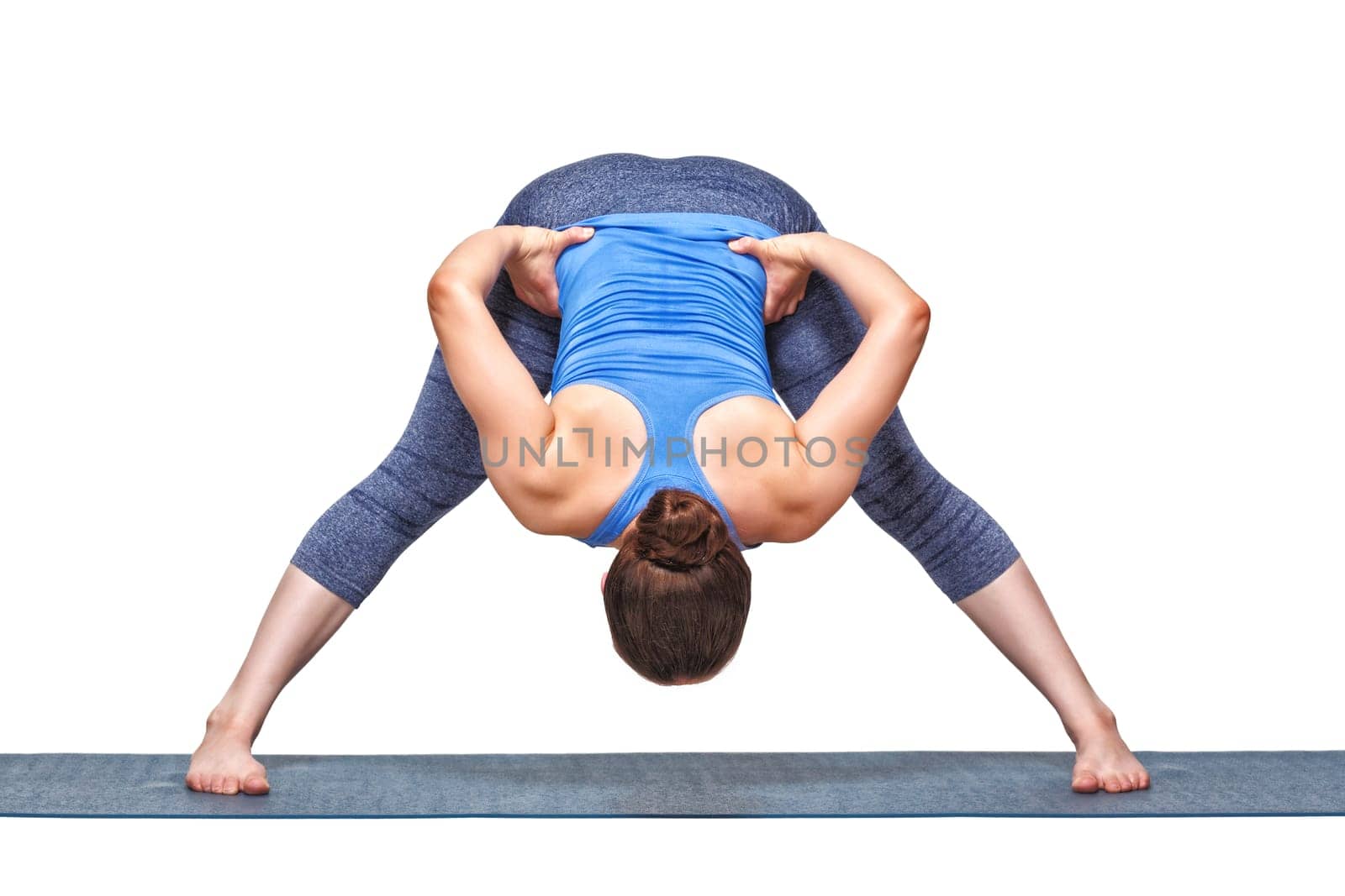 Sporty fit woman doing yoga asana Prasarita padottanasana B by dimol