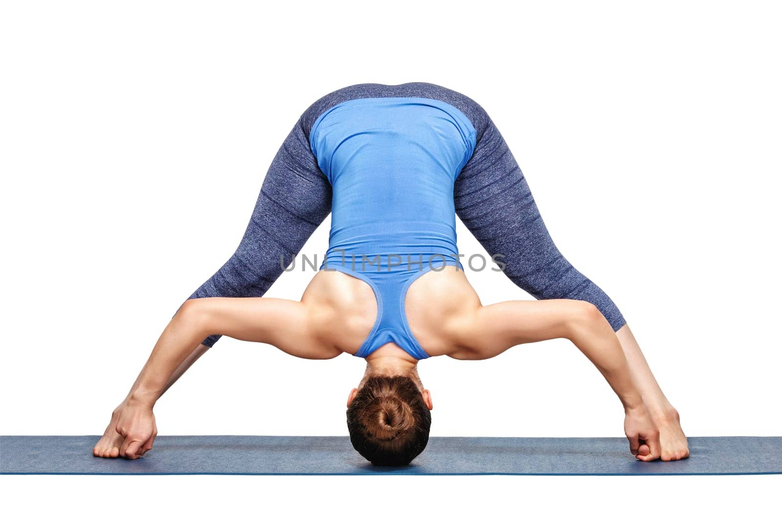 Beautiful sporty fit woman practices Ashtanga Vinyasa yoga asana Prasarita padottanasana D - wide legged forward bend D isolated on white
